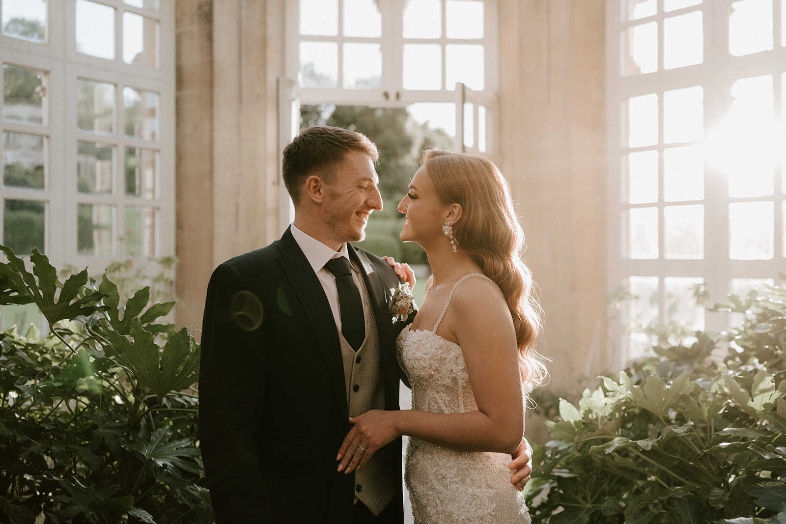 bride and groom in conservatory at harlaxton manor