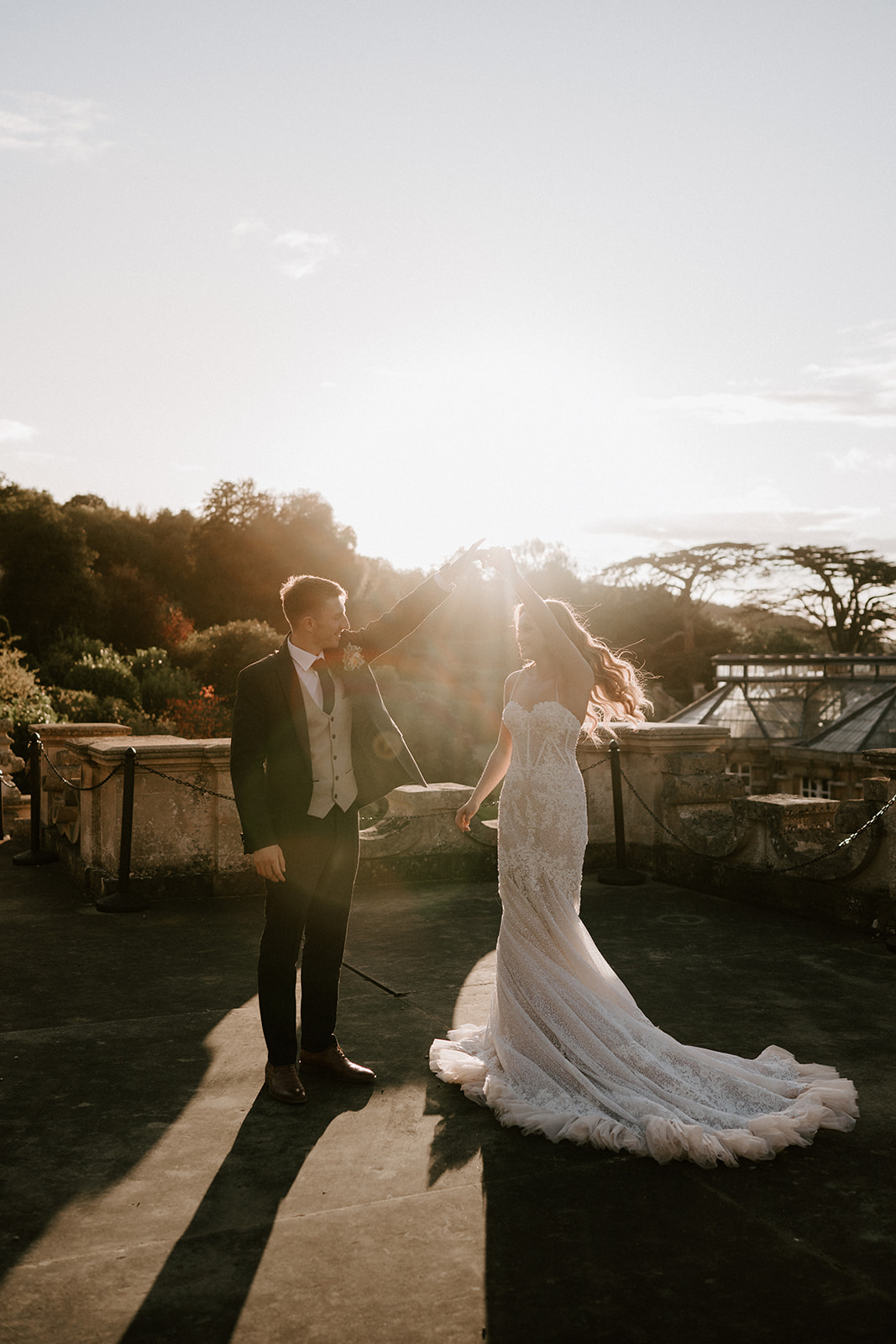 bride and groom dancing at golden hour at harlaxton manor
