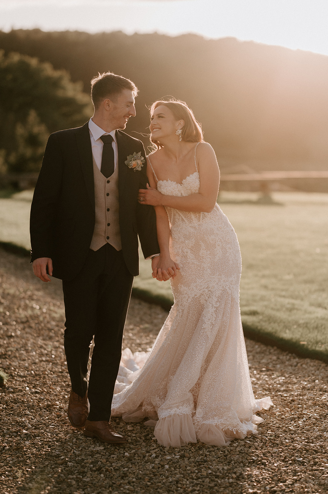 bride and groom at golden hour outside harlaxton manor