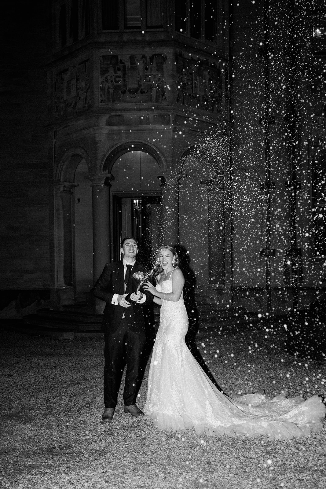 bride and groom spraying champagne