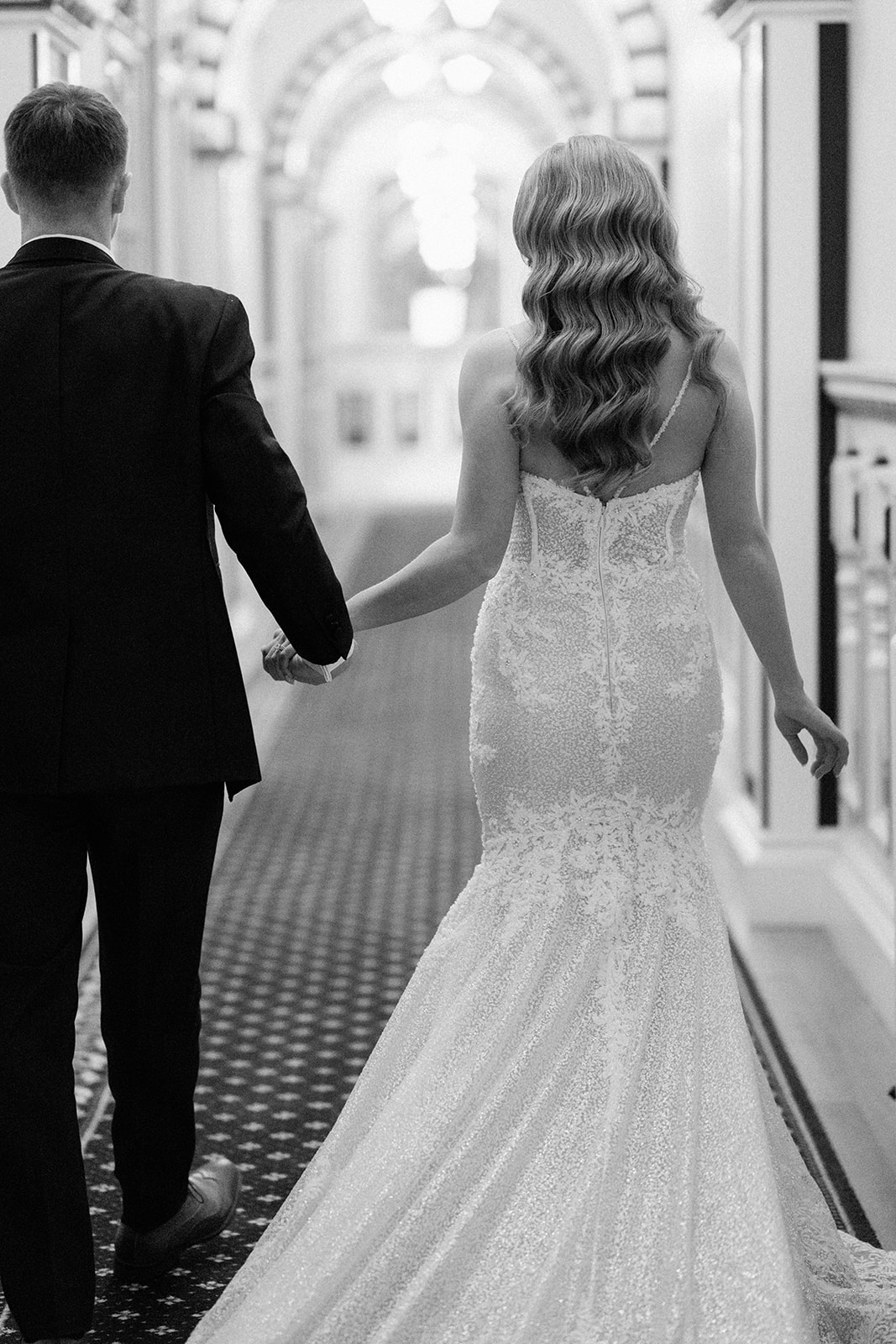 bride and groom walking down corridor