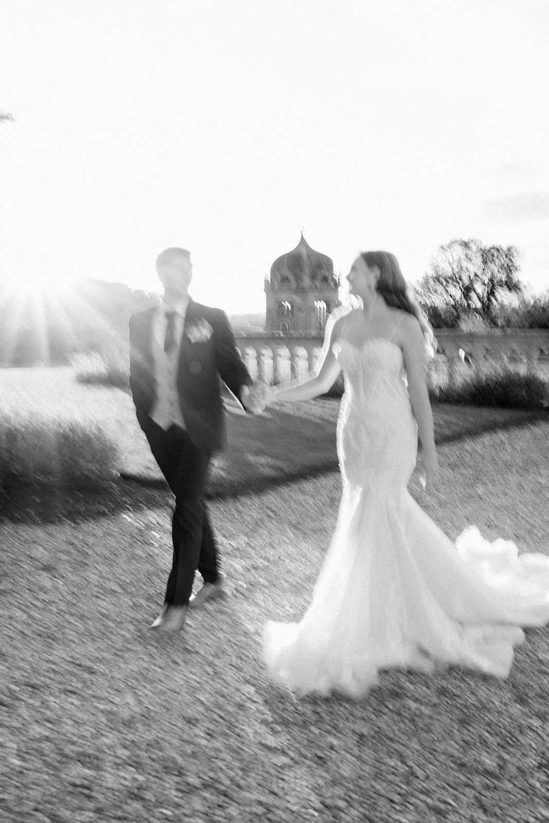bride and groom walking at harlaxton manor