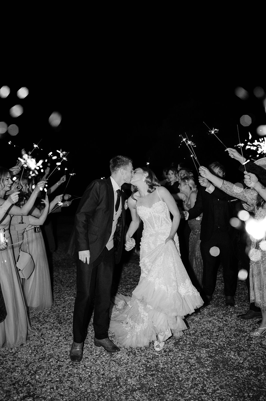 bride and groom walking through sparkler exit
