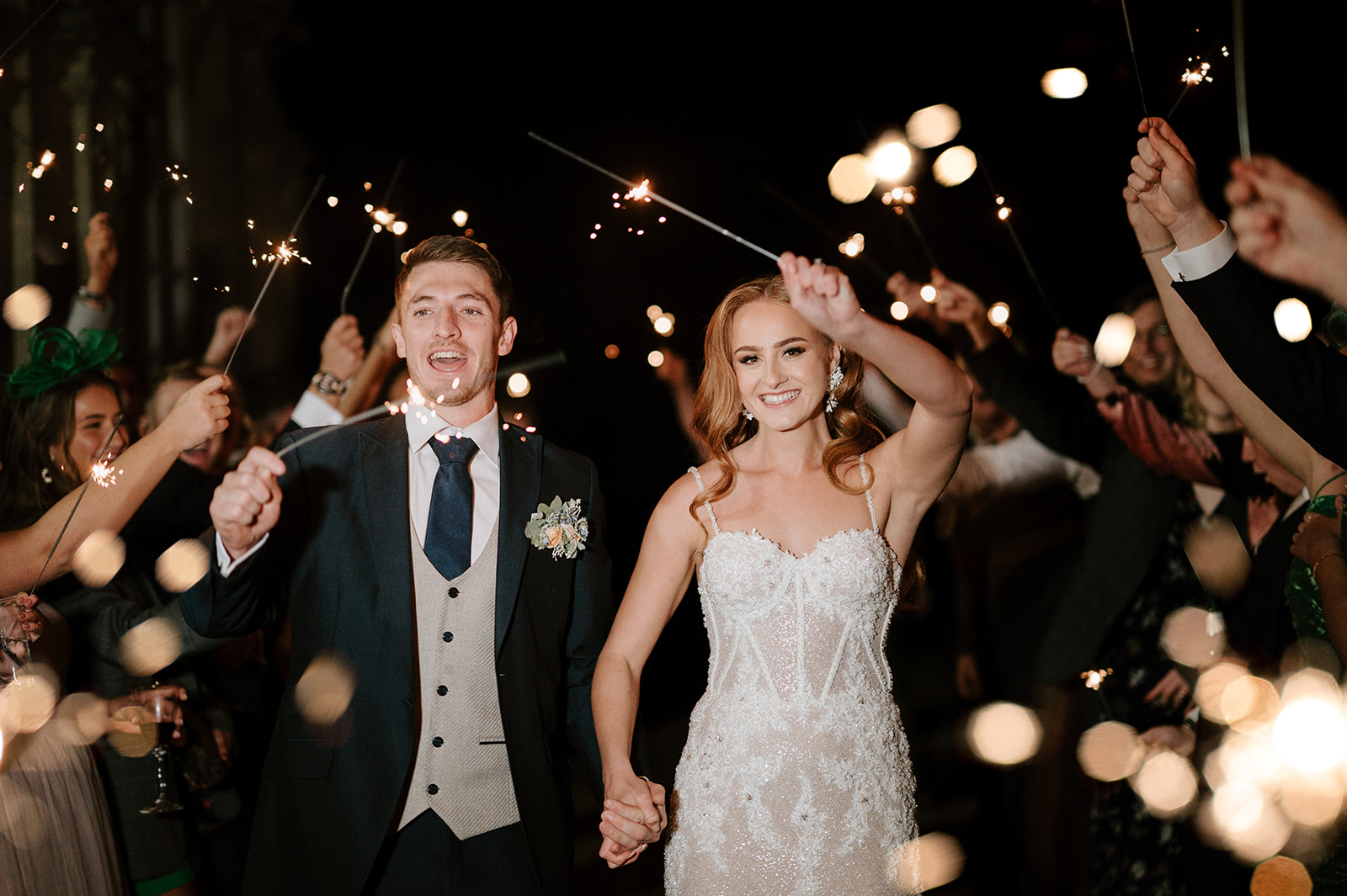 bride and groom walking through sparkler exit
