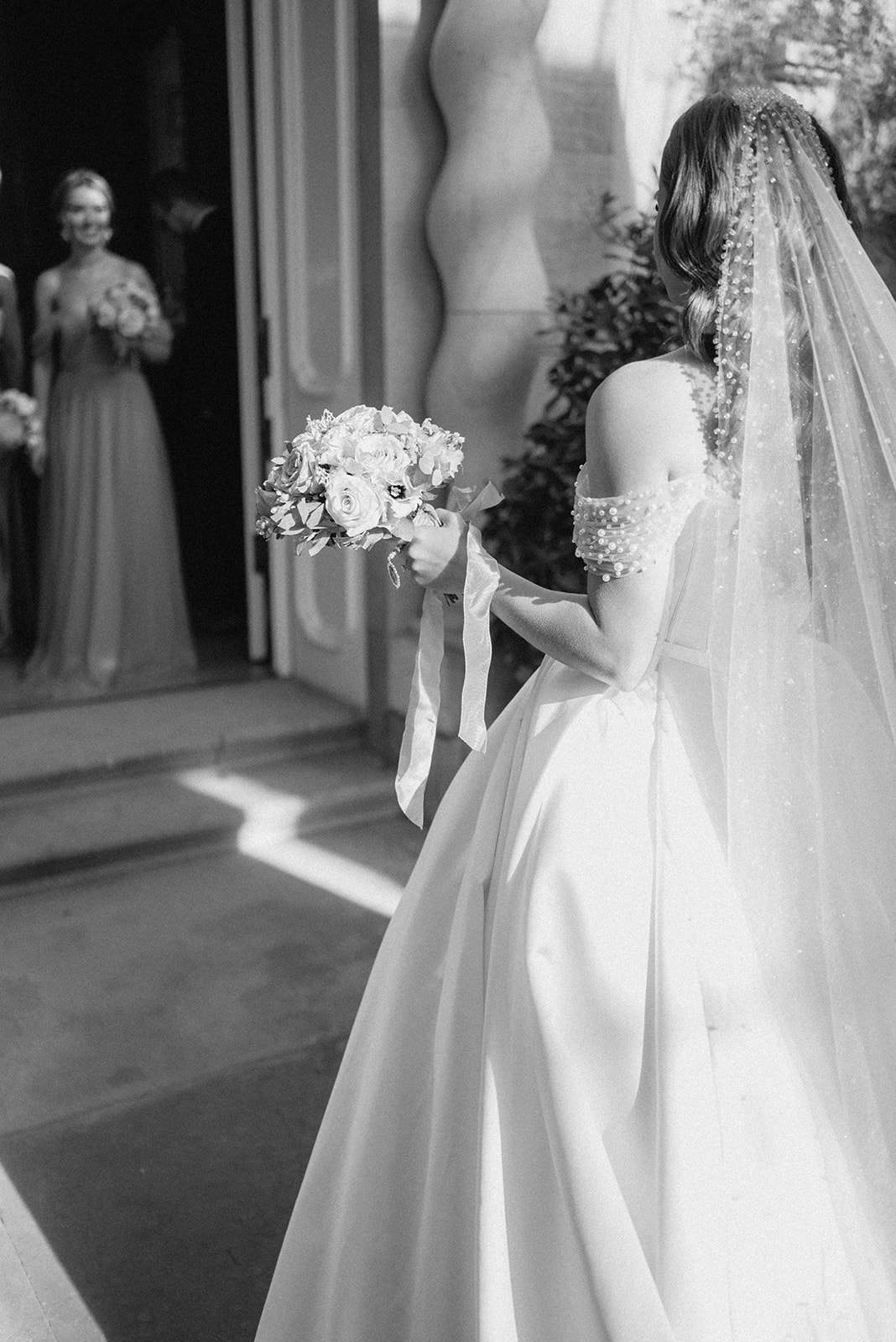 bride wearing veil holding bouquet