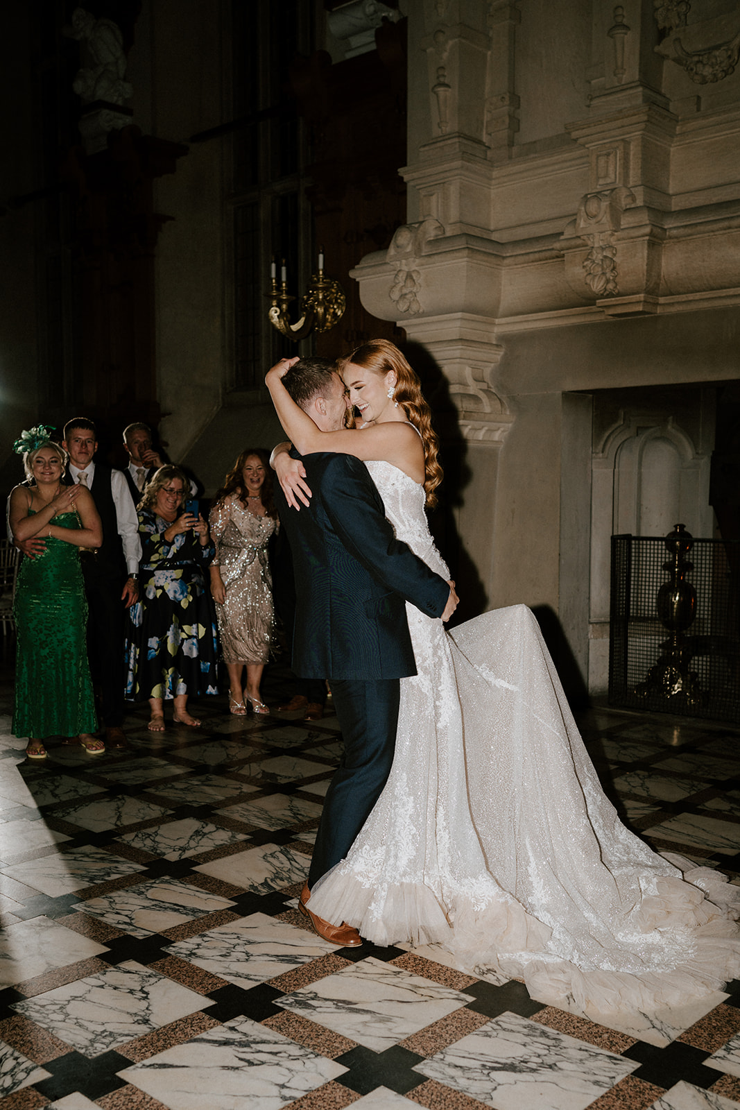 groom picking up bride during first dance at harlaxton manor
