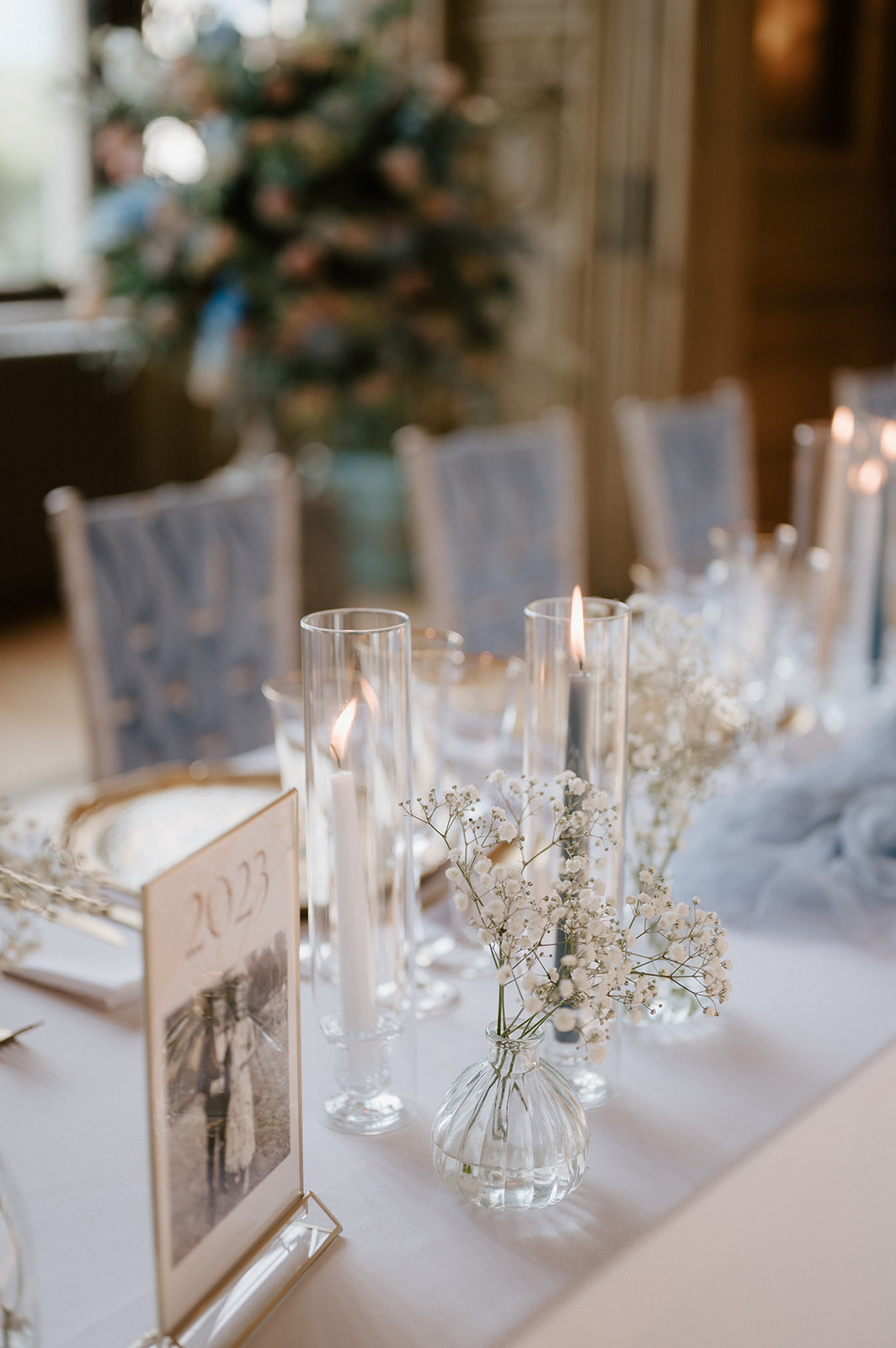 wedding breakfast set up in the long gallery at harlaxton manor with candles