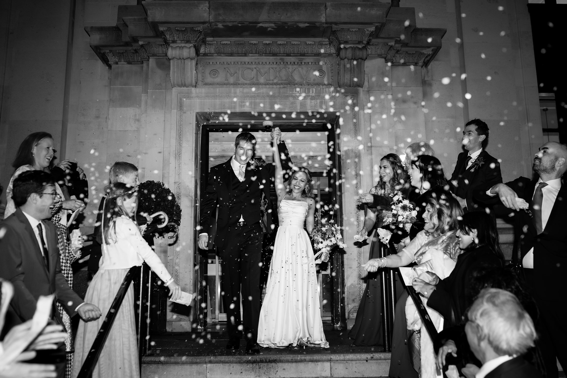 black and white photo of confetti exit at islington town hall on a dar wintery evening