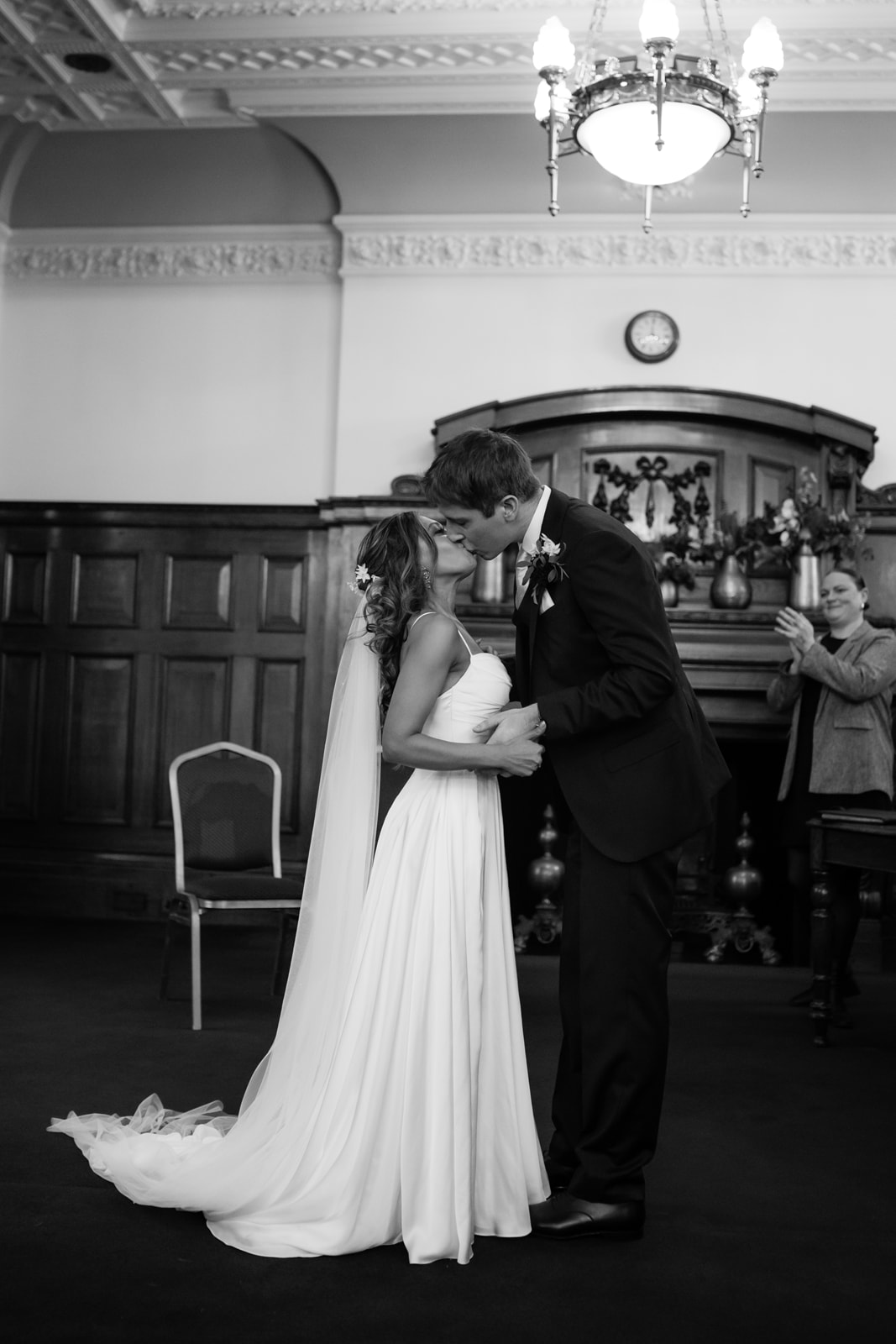 first kiss of bride and groom at islington town hall richmond suite, in black and white