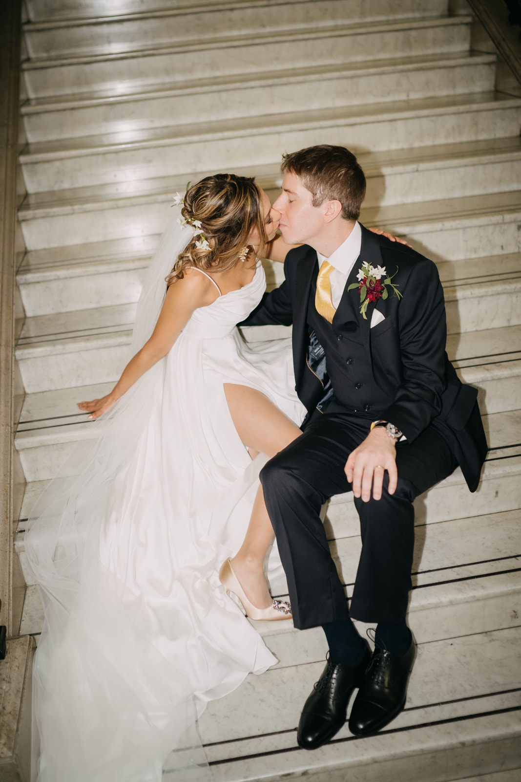 bride and groom kissing on islington town hall stairs, direct flash wedding photography