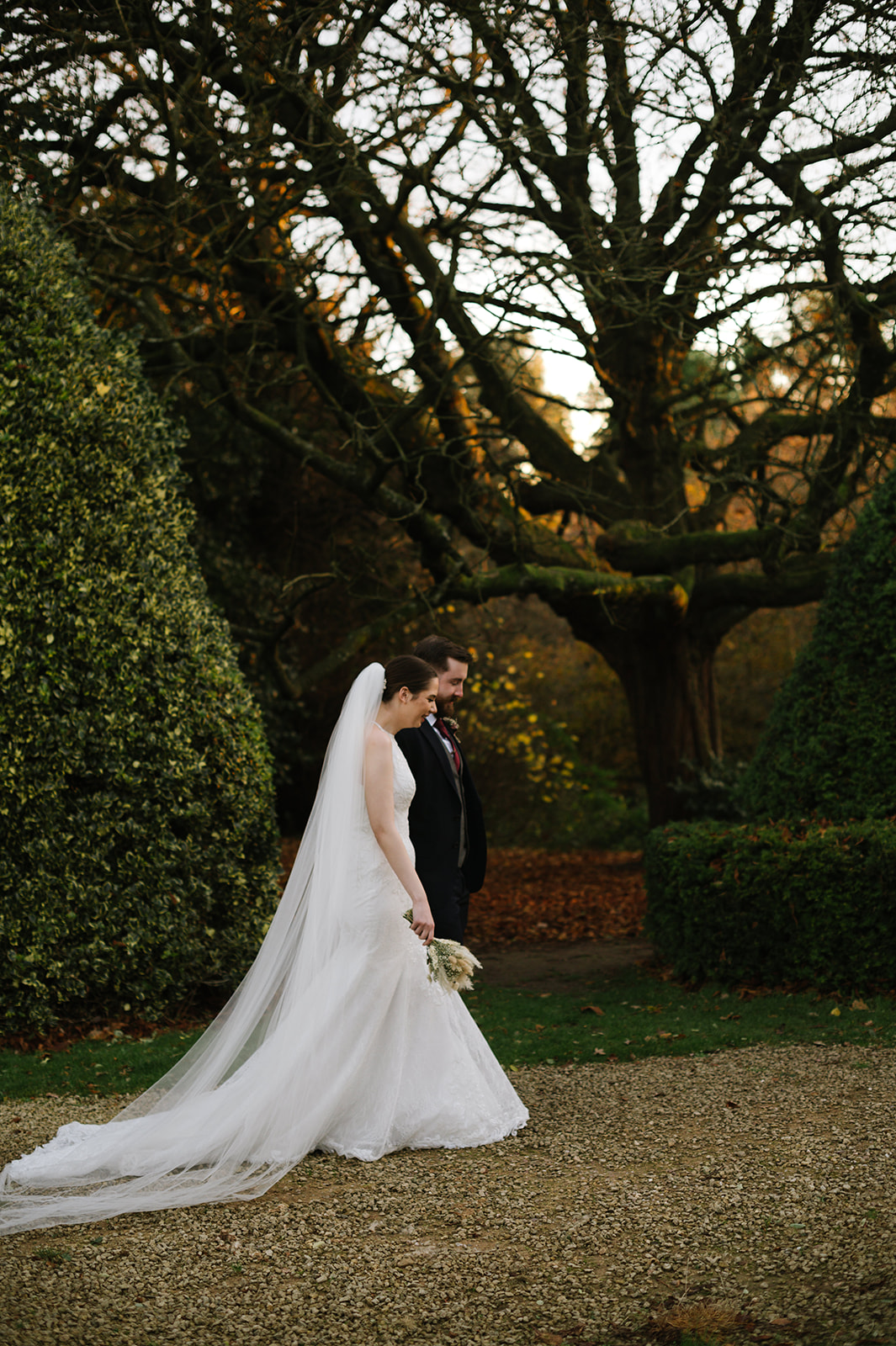 the bride and groom walking in the garden at highbury hall, Birmingham