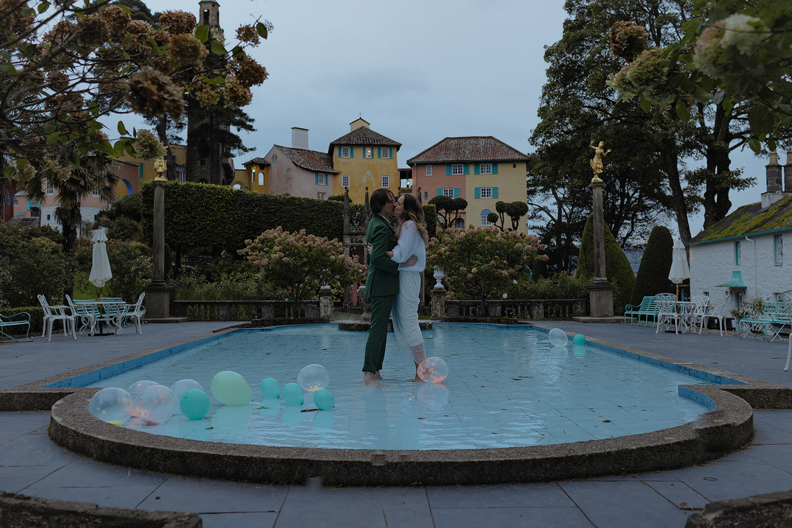 bride and groom standing in pool at Frances quinn wedding in wales