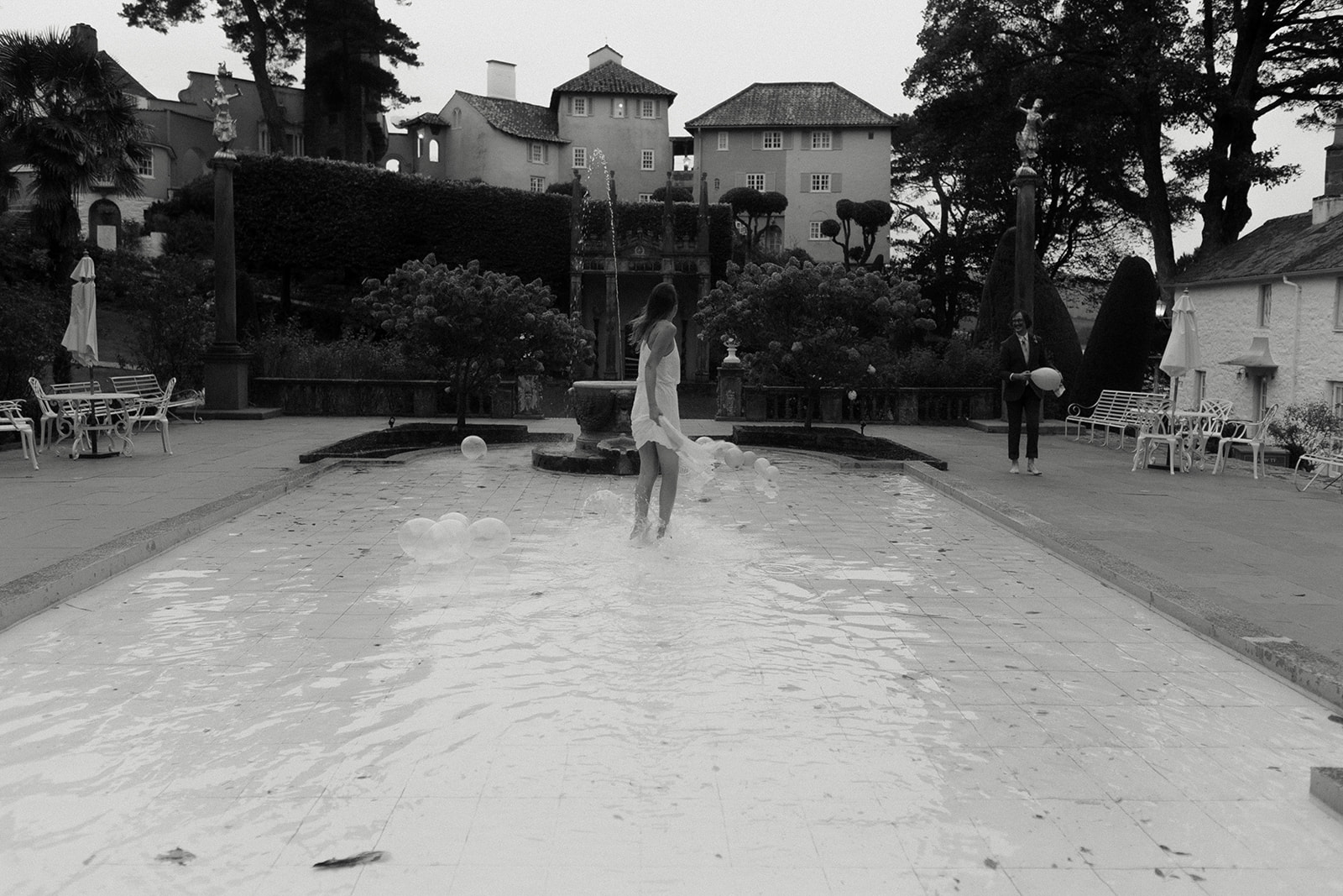 bride and groom standing in pool at Frances quinn wedding in wales