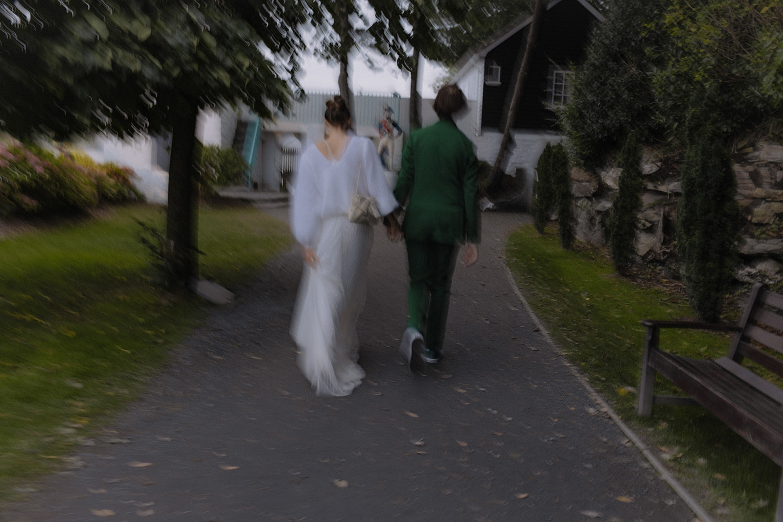 bride and groom walking together at sunset at Frances quinn wedding in wales