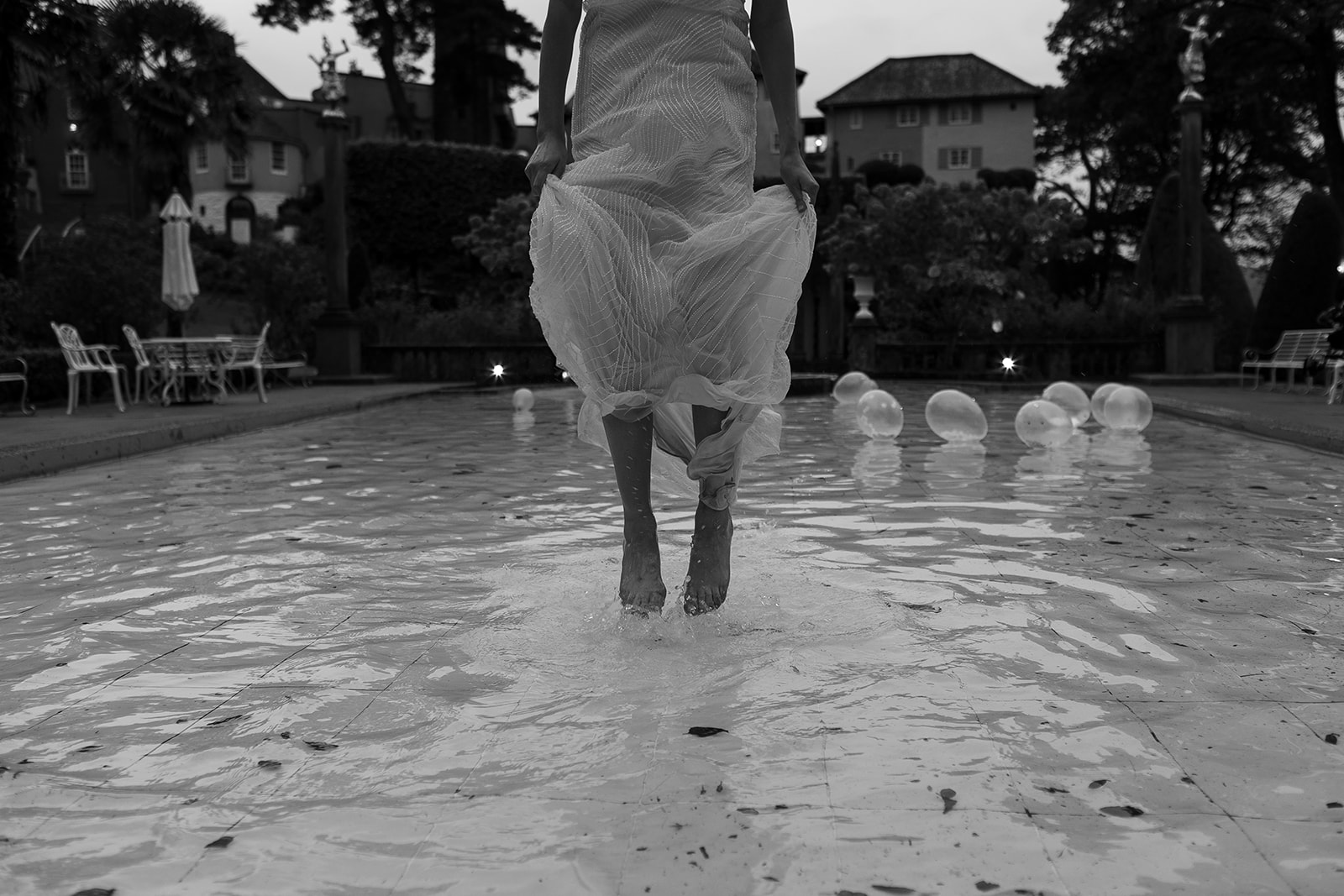 bride splashing in pool at Frances quinn wedding in wales