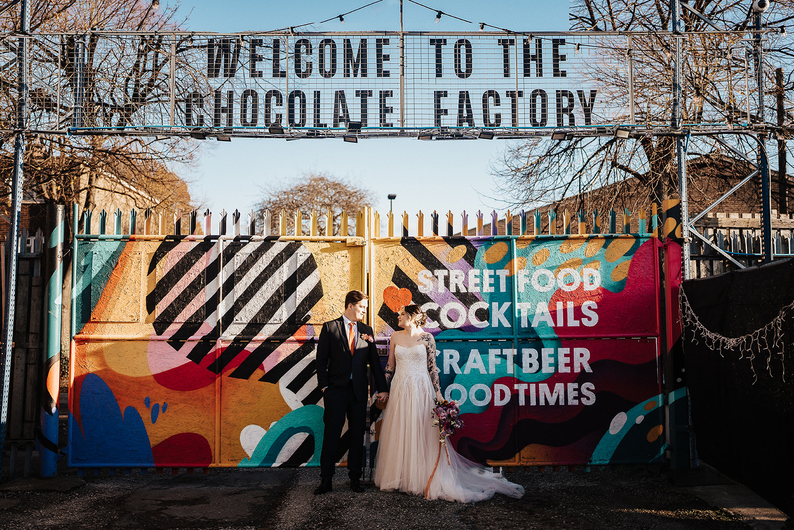 couple against colourful background  | The Chocolate Factory Wedding Derby