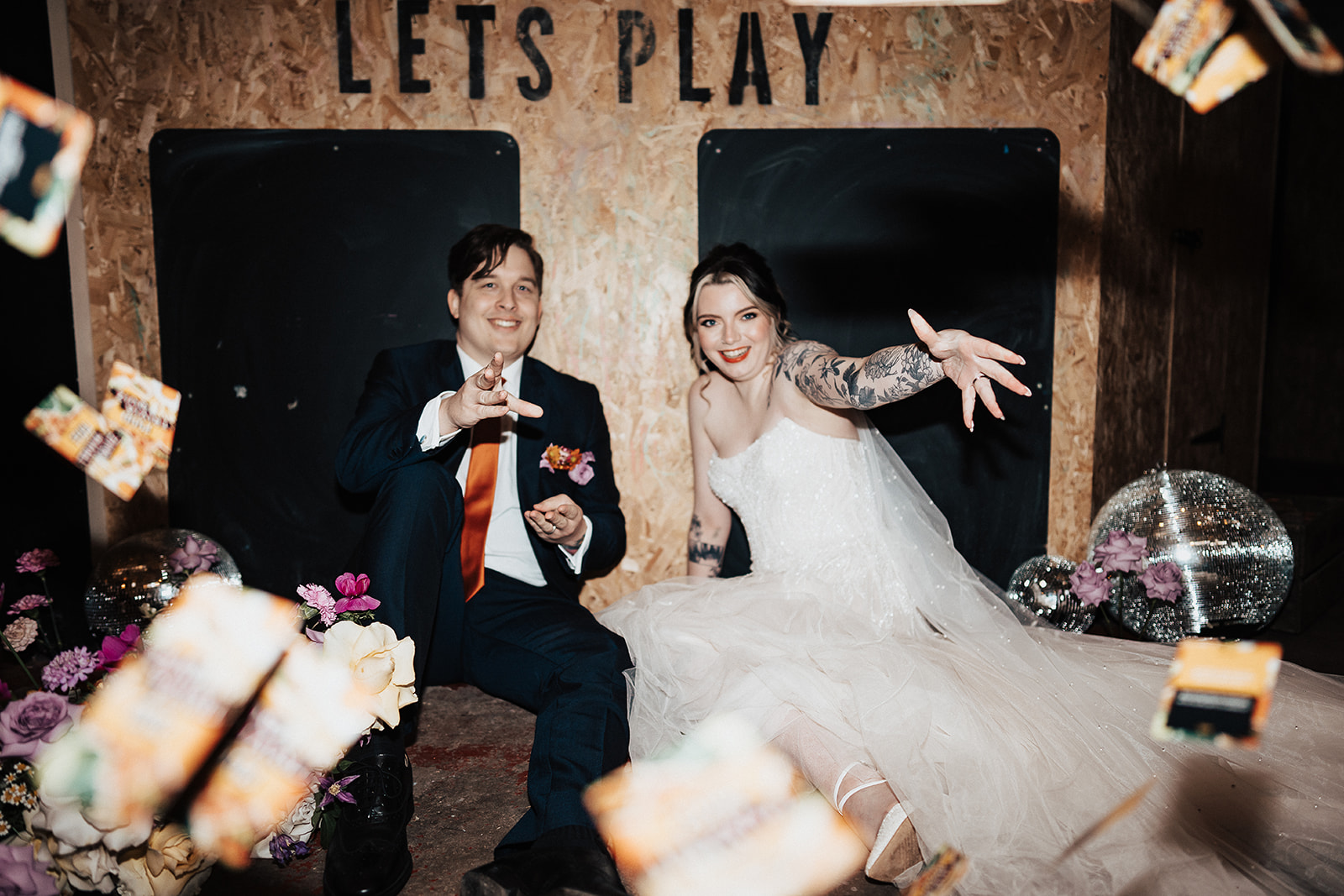 couple throw playing cards  | Chocolate Factory Wedding Derby