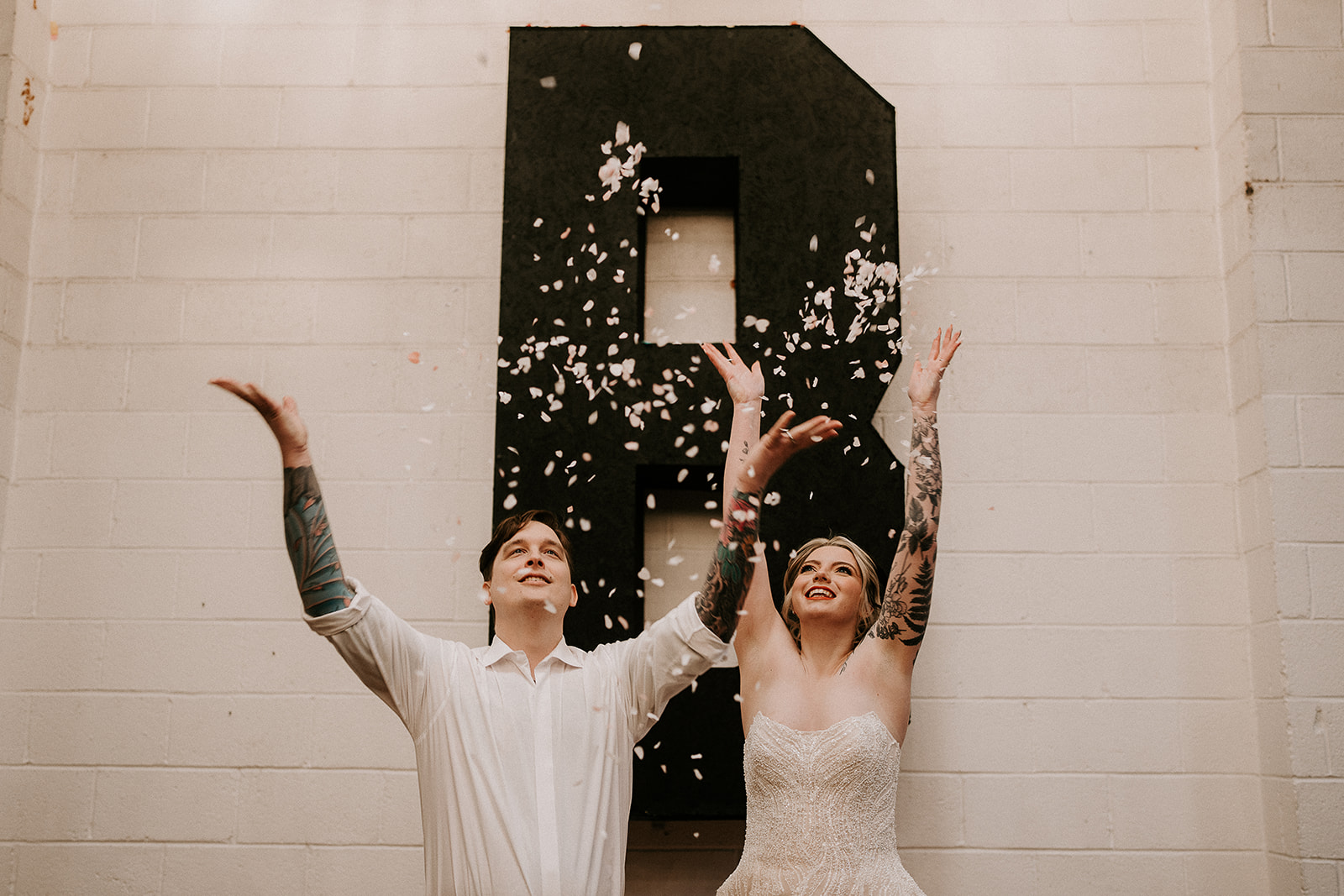 couple with confetti couple kiss | Chocolate Factory Wedding Derby