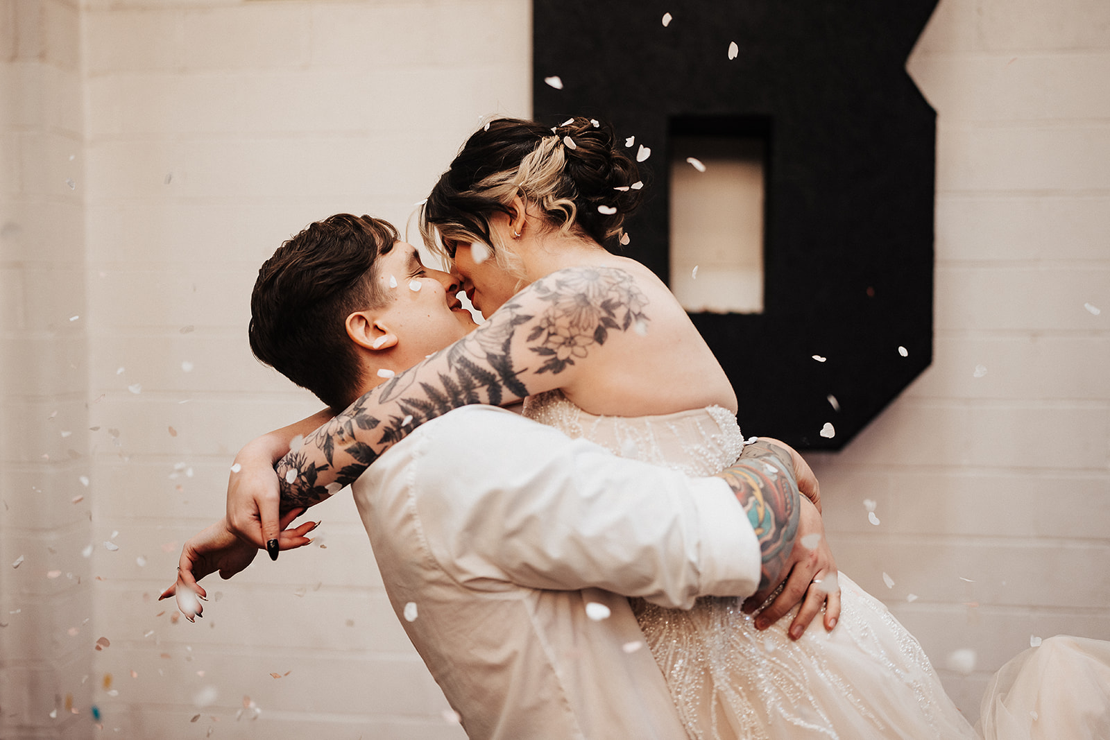 couple with confetti couple kiss | Chocolate Factory Wedding Derby