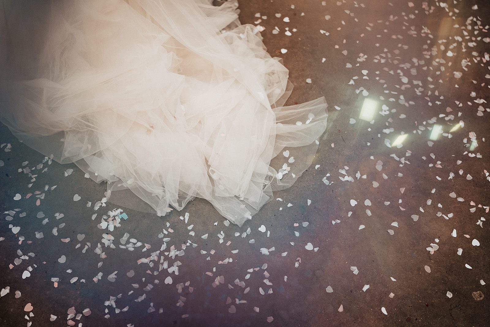 confetti on the industrial floor couple kiss | Chocolate Factory Wedding Derby