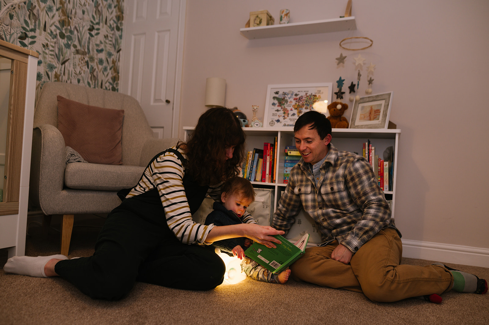 Family reading with their one year old 