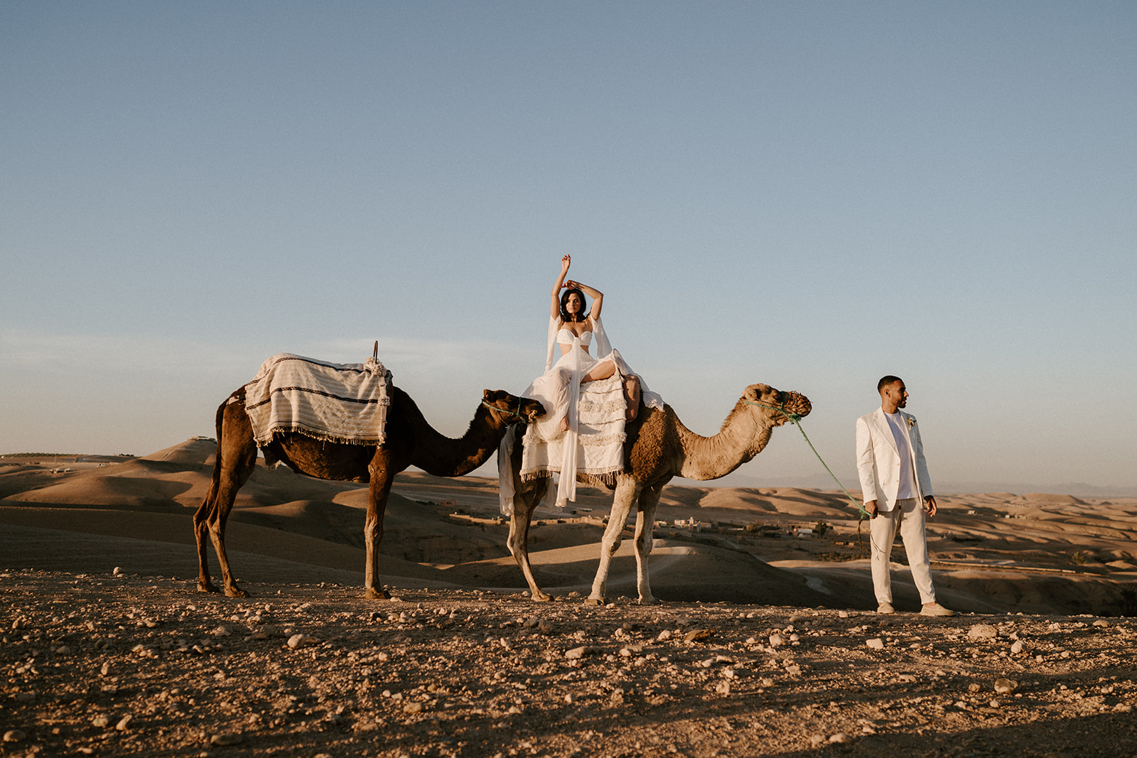 bride on camel walking with groom at agafay desert in marrakesh