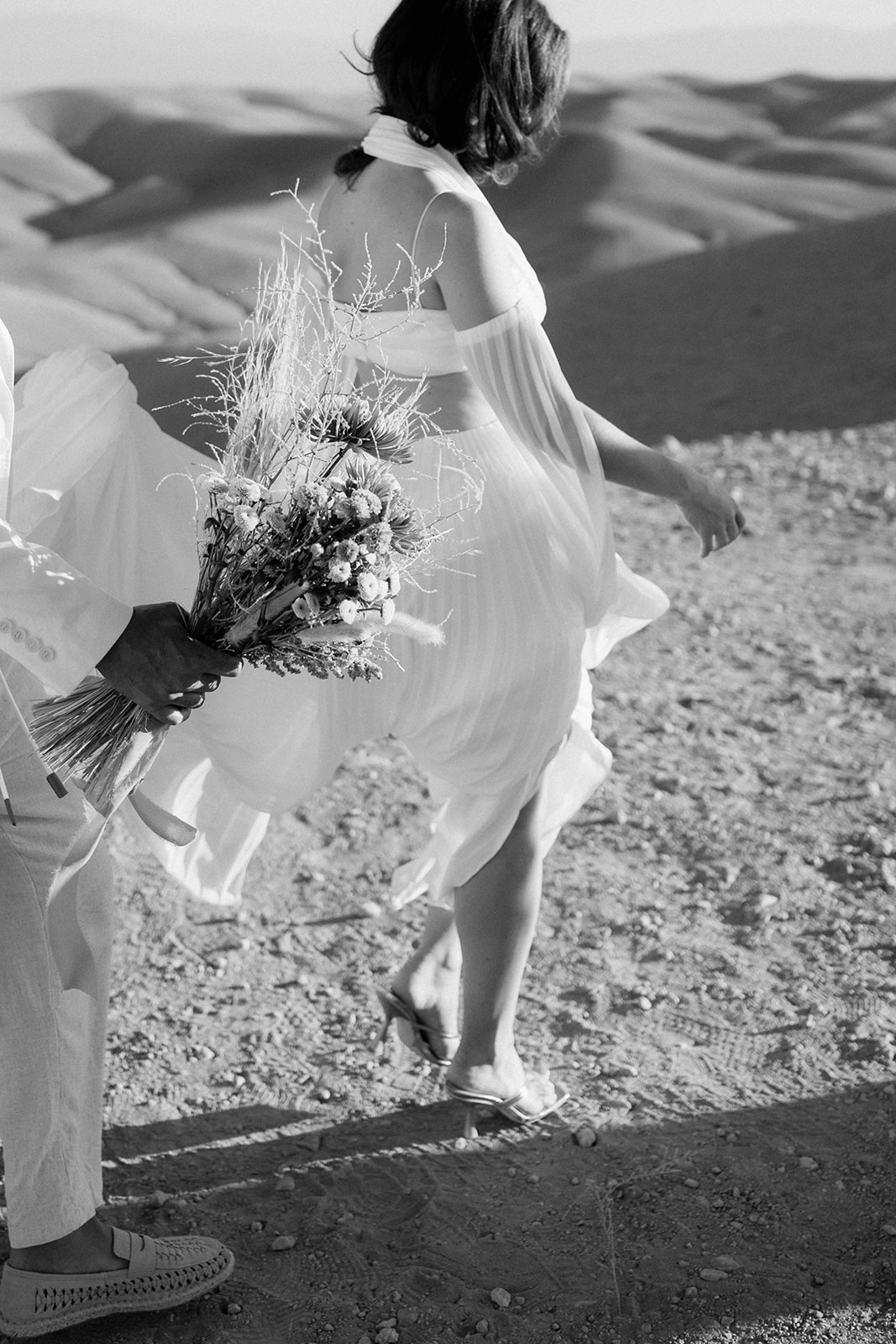 couple walking to agafay desert wedding elopement 
