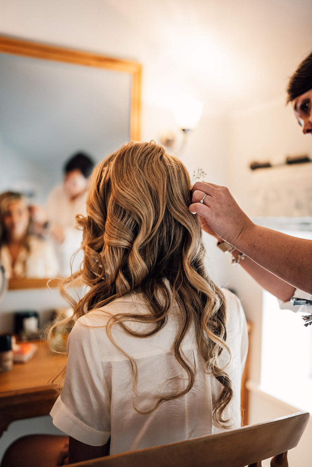 The bride having her hair styled