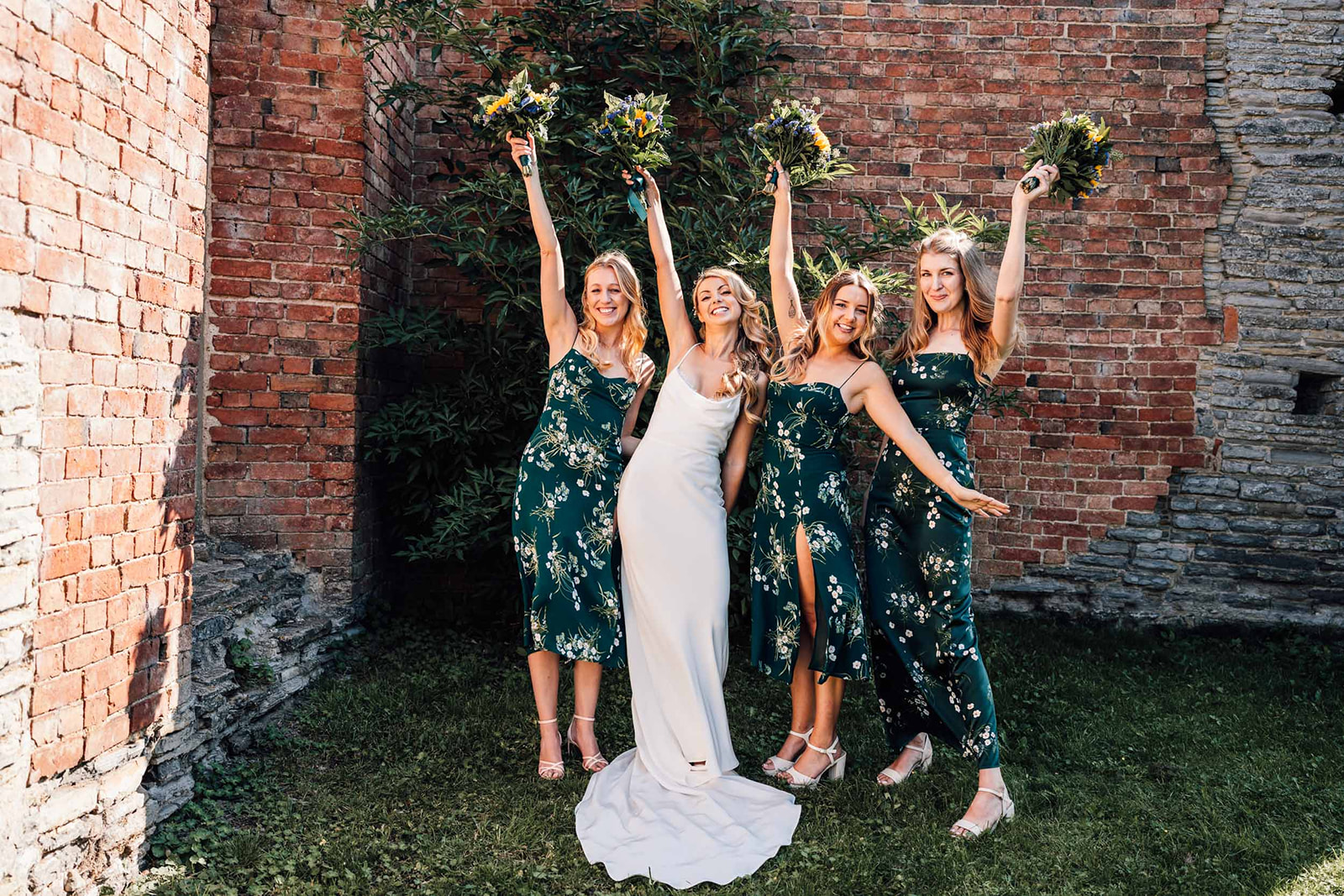 bridesmaids holding flowers in the air