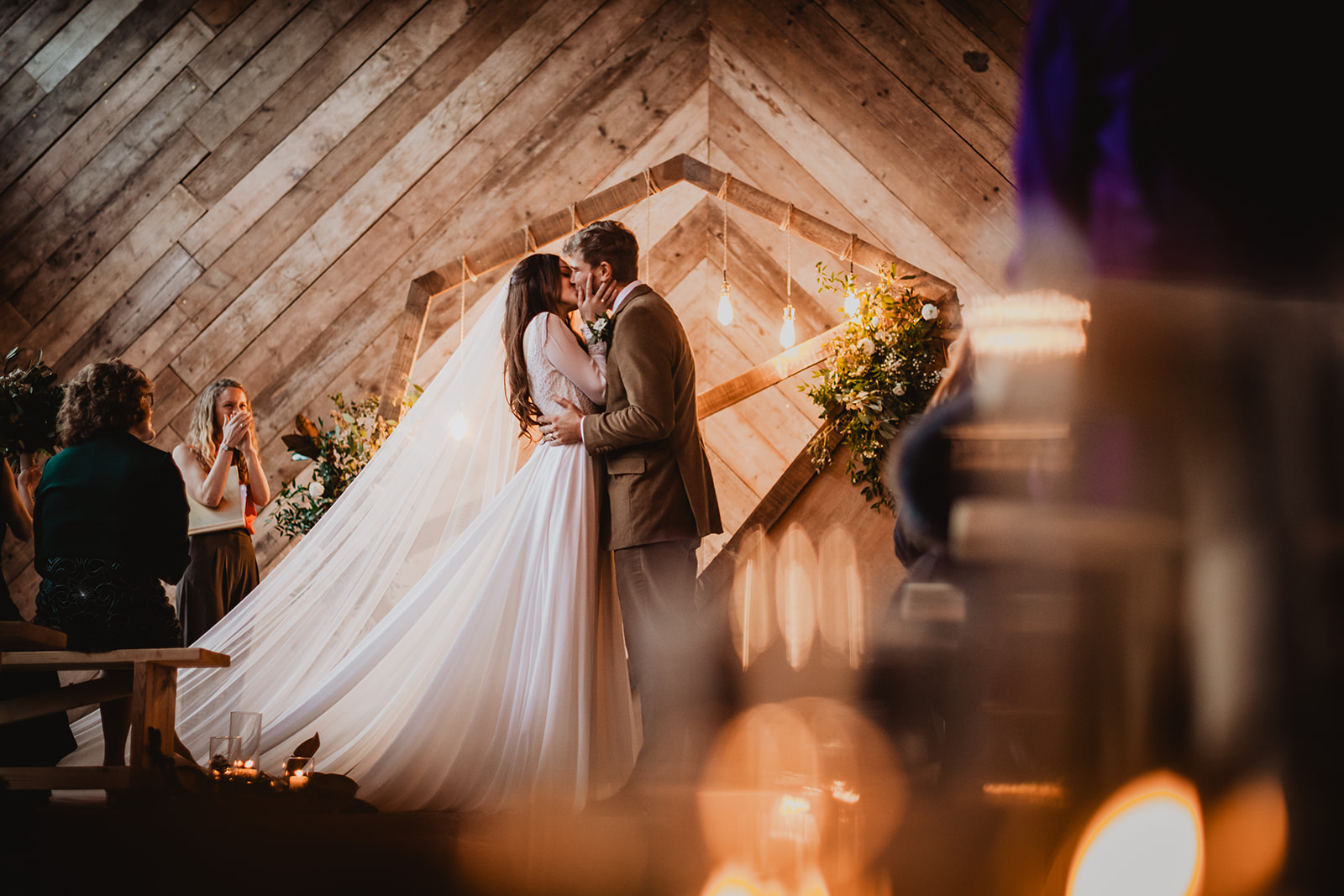 A bride and groom share a romantic first kiss at the Manor Barn in Harlton