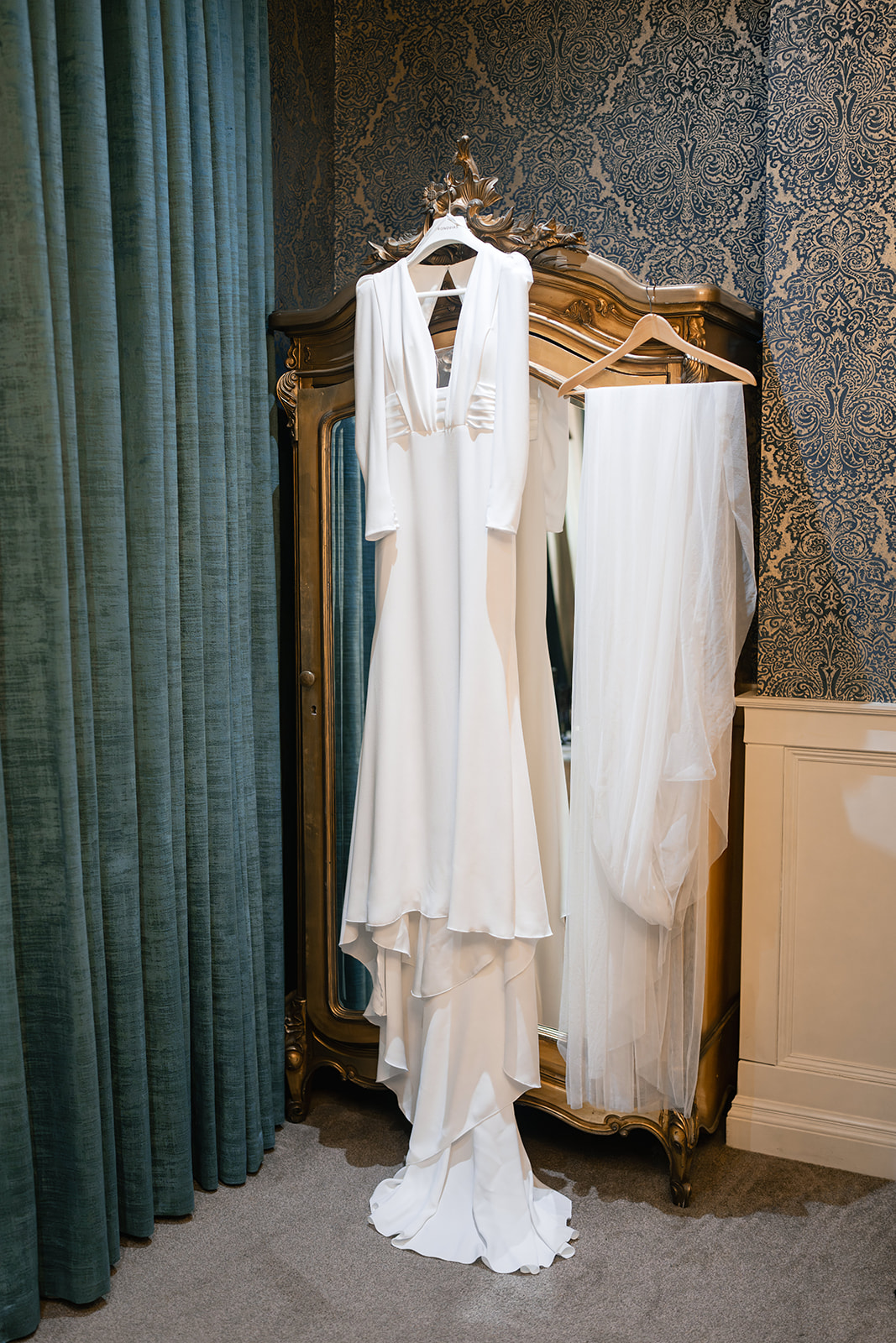 wedding dress hung up on wardrobe 