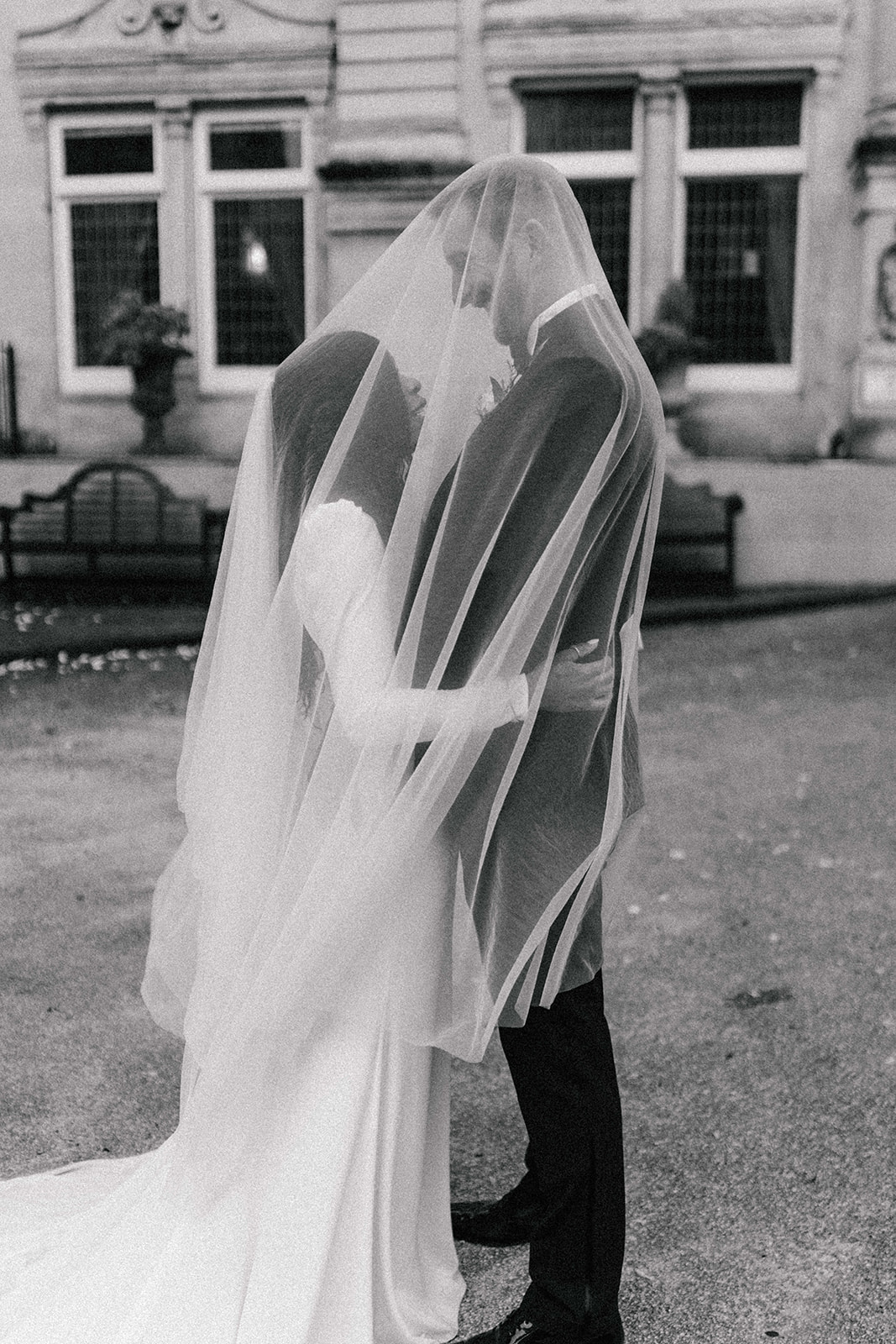 wedding couple underneath bridal veil 