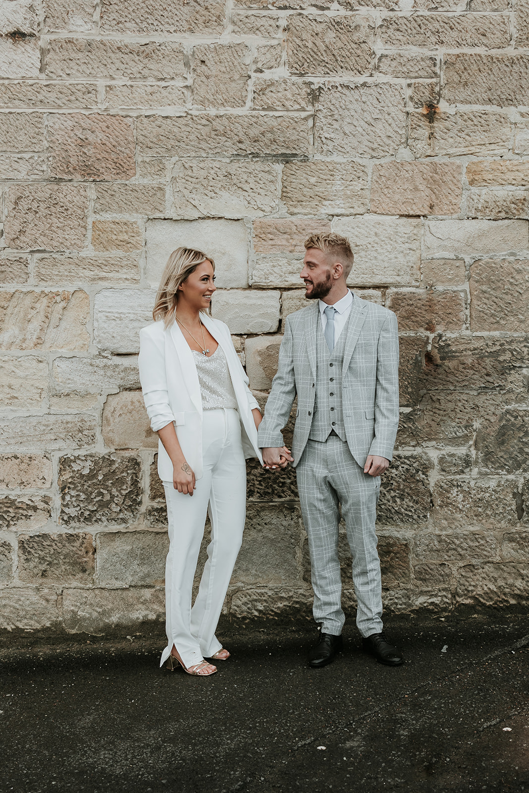 bride and groom both wearing wedding suits