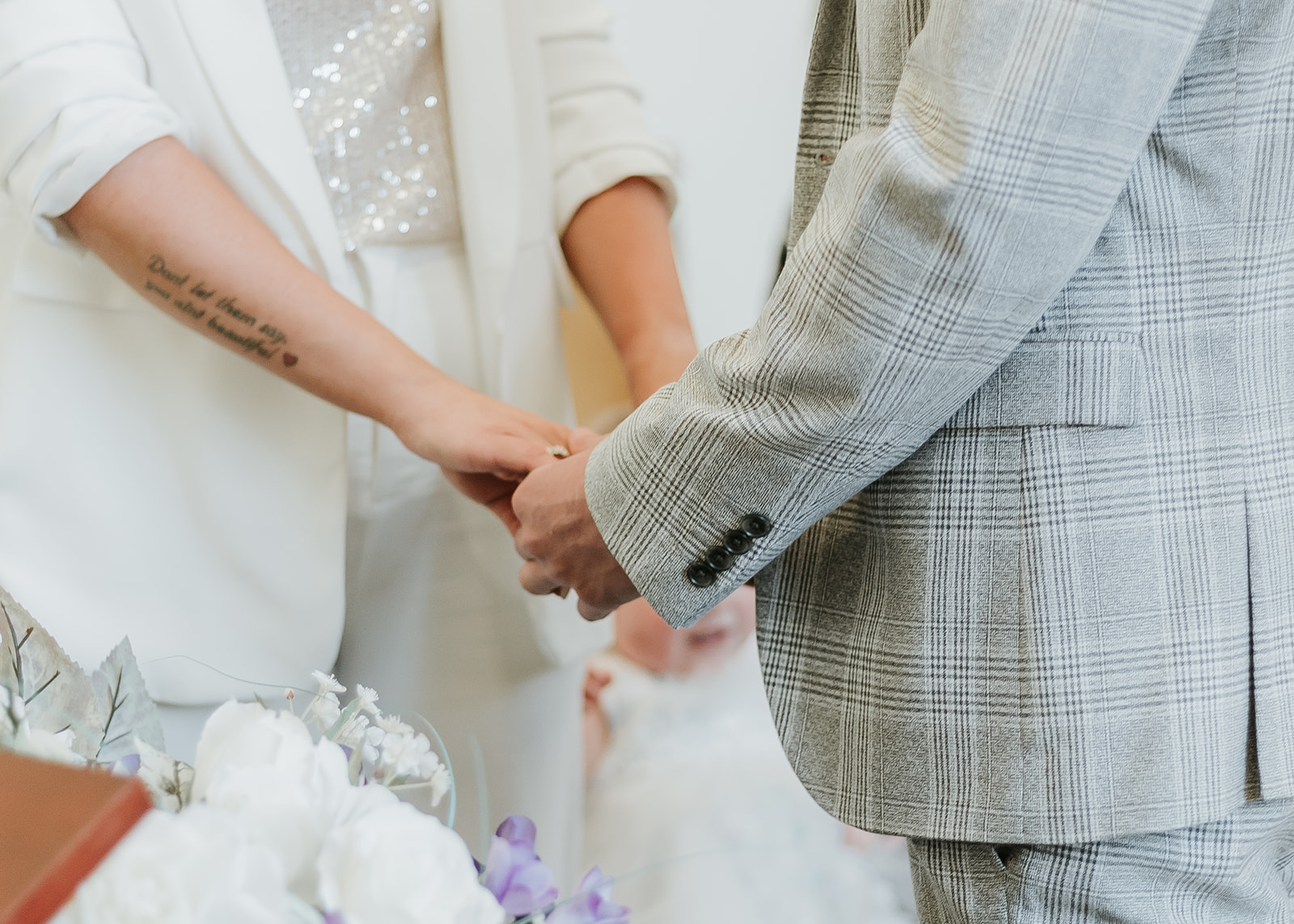 bride and groom holding hands during ceremony 