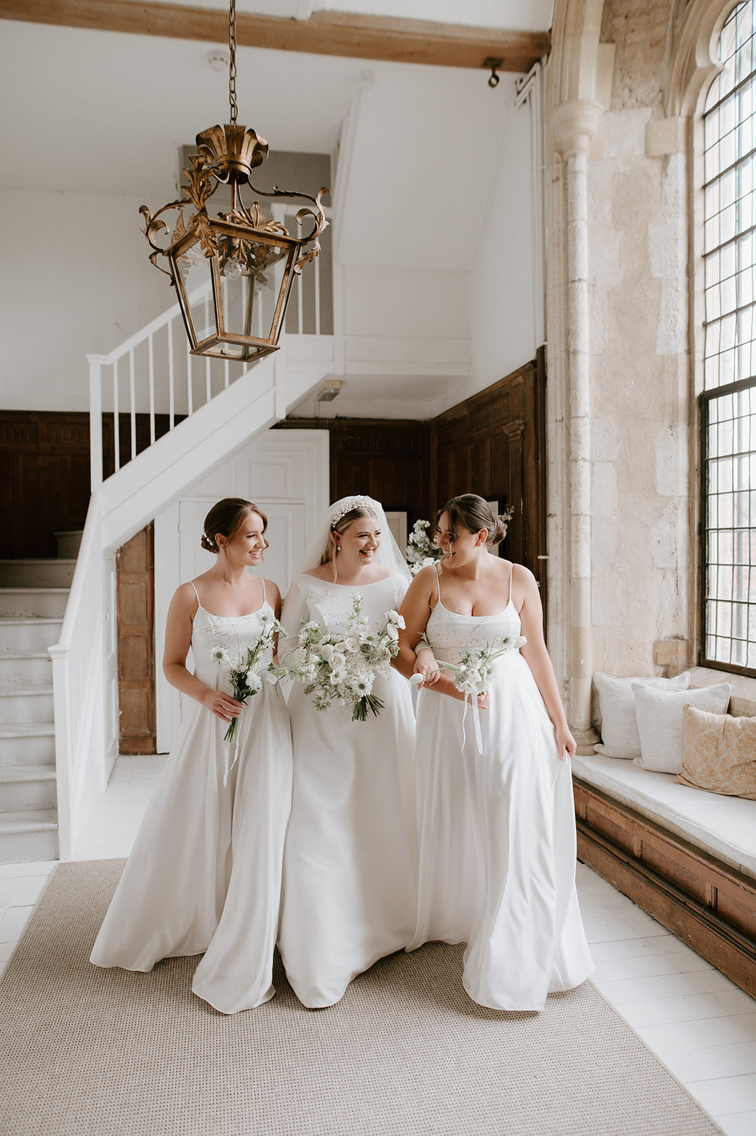 bride and bridesmaids wearing white dresses at butley priory