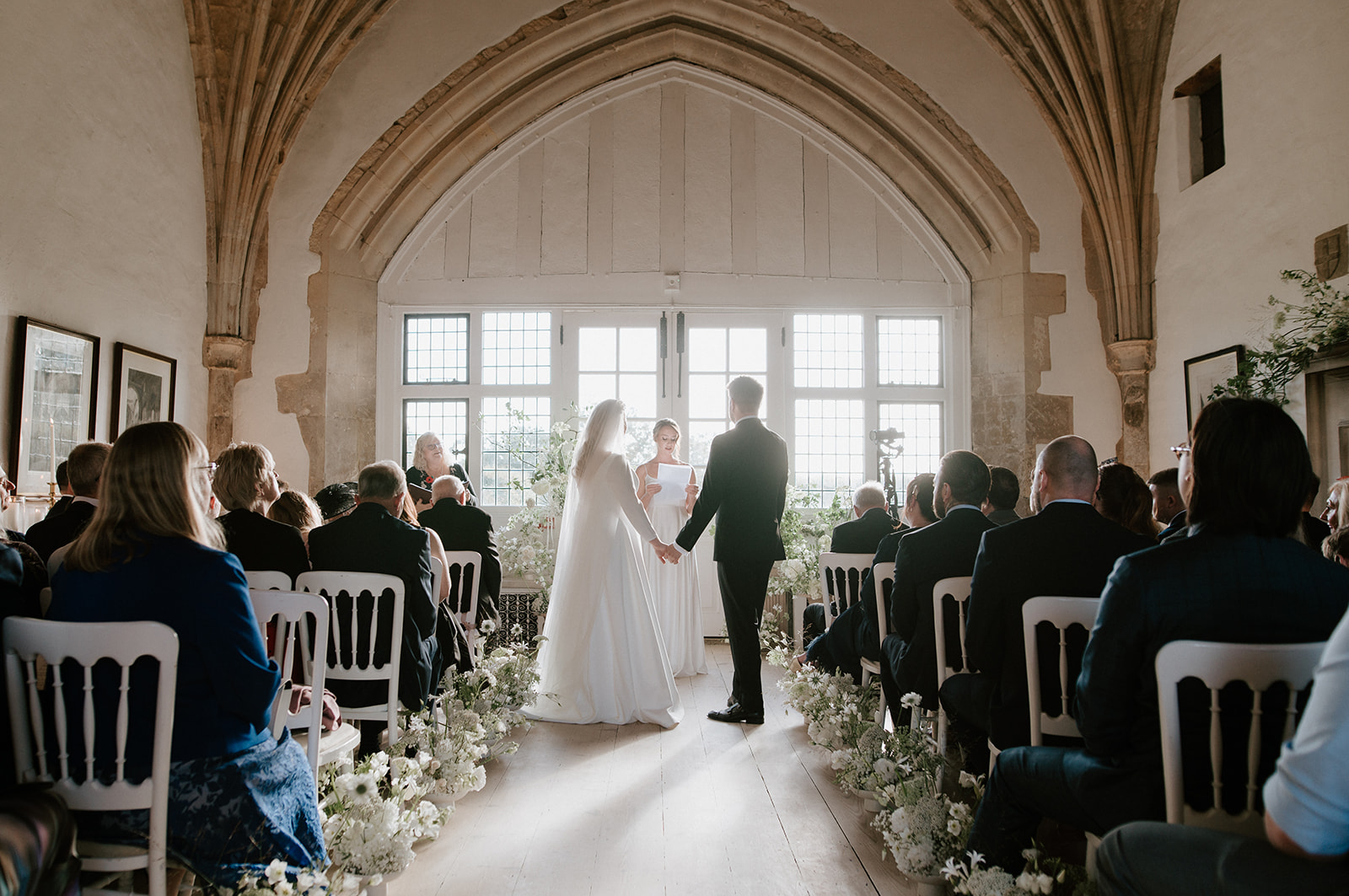 bride and groom getting married in great hall at butley priory