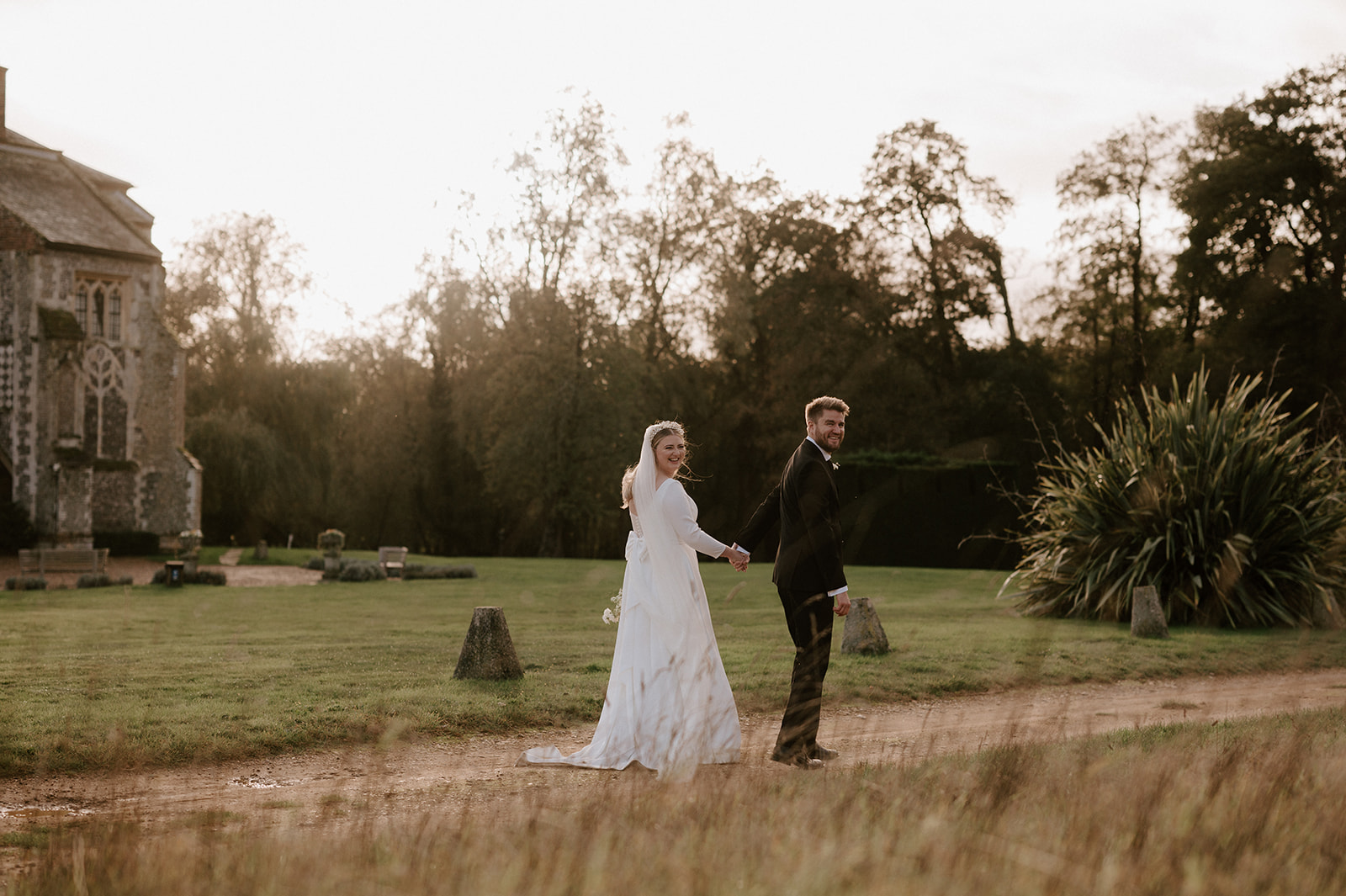 bride and groom at golden hour at butley priory wedding