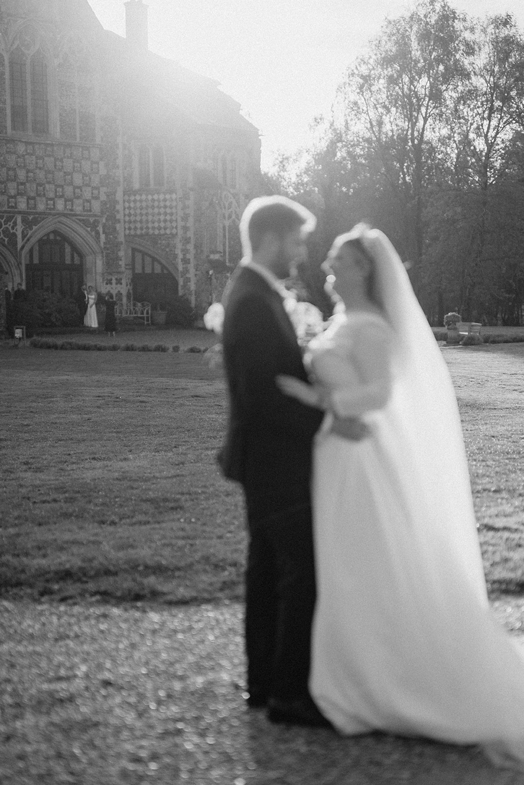 bride and groom walking at golden hour butley priory wedding