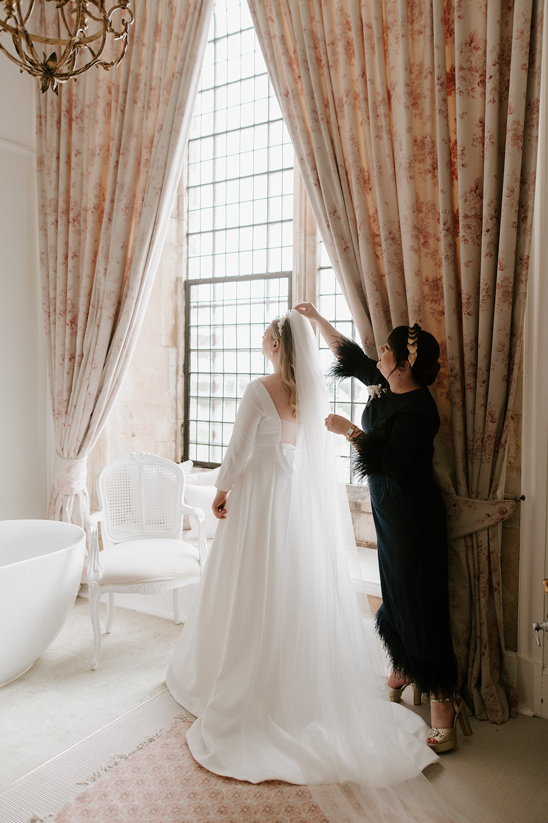 brides sister putting in veil in bridal suite at butley priory