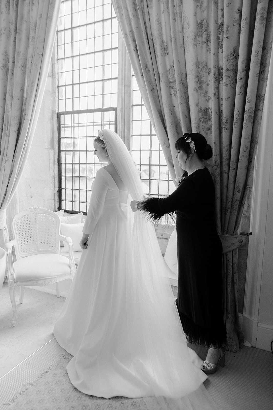 brides sister putting in veil in bridal suite at butley priory