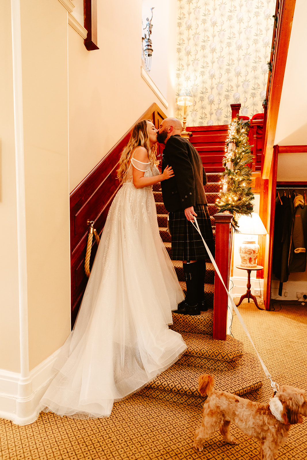 bride and groom. kiss on staircase at raemoir hosue