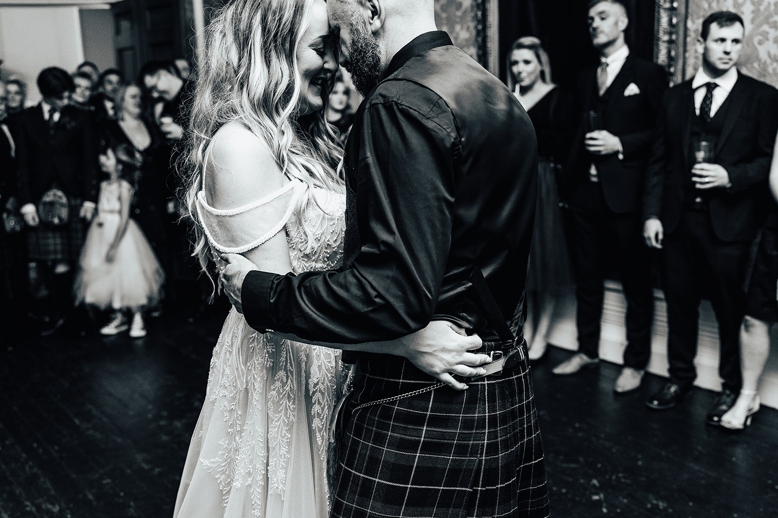 bride and groom closely embrace during their first dance at raemoir house