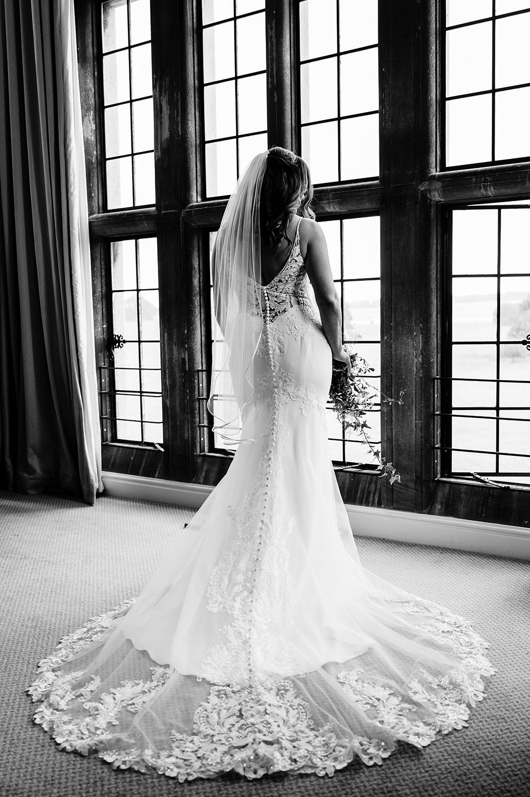 bride posing in front of the window in the bridal suite at stapleford park hotel by Amanda Forman Photography