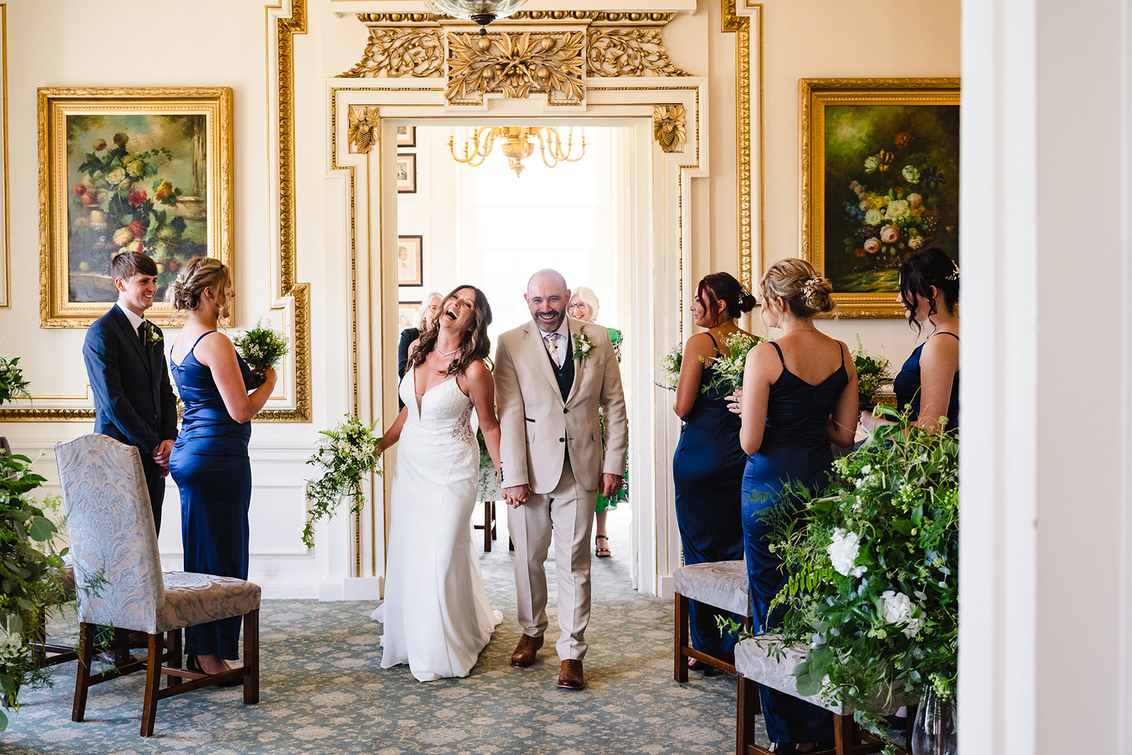 Bride and groom walking down the aisle during their intimate wedding ceremony at Stapleford Park Hotel by Amanda Forman 