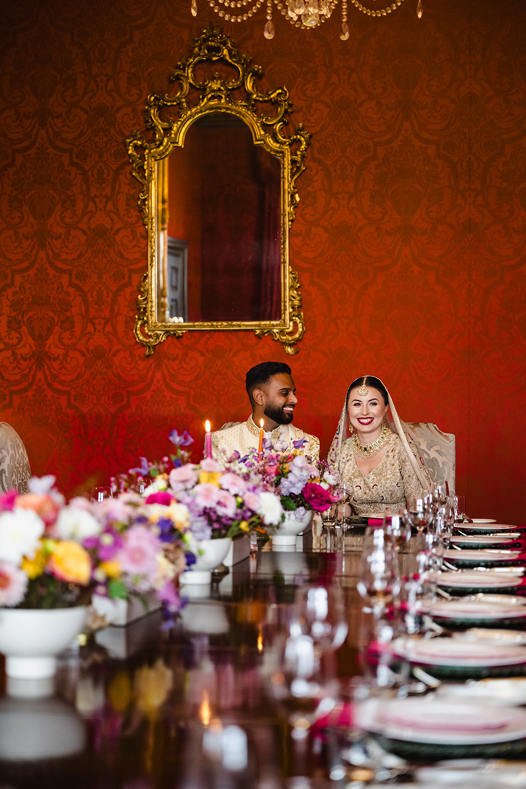 Portrait of a bride and groom sitting at their wedding breakfast table at Stapleford Park Hotel by Amanda Forman Photogr