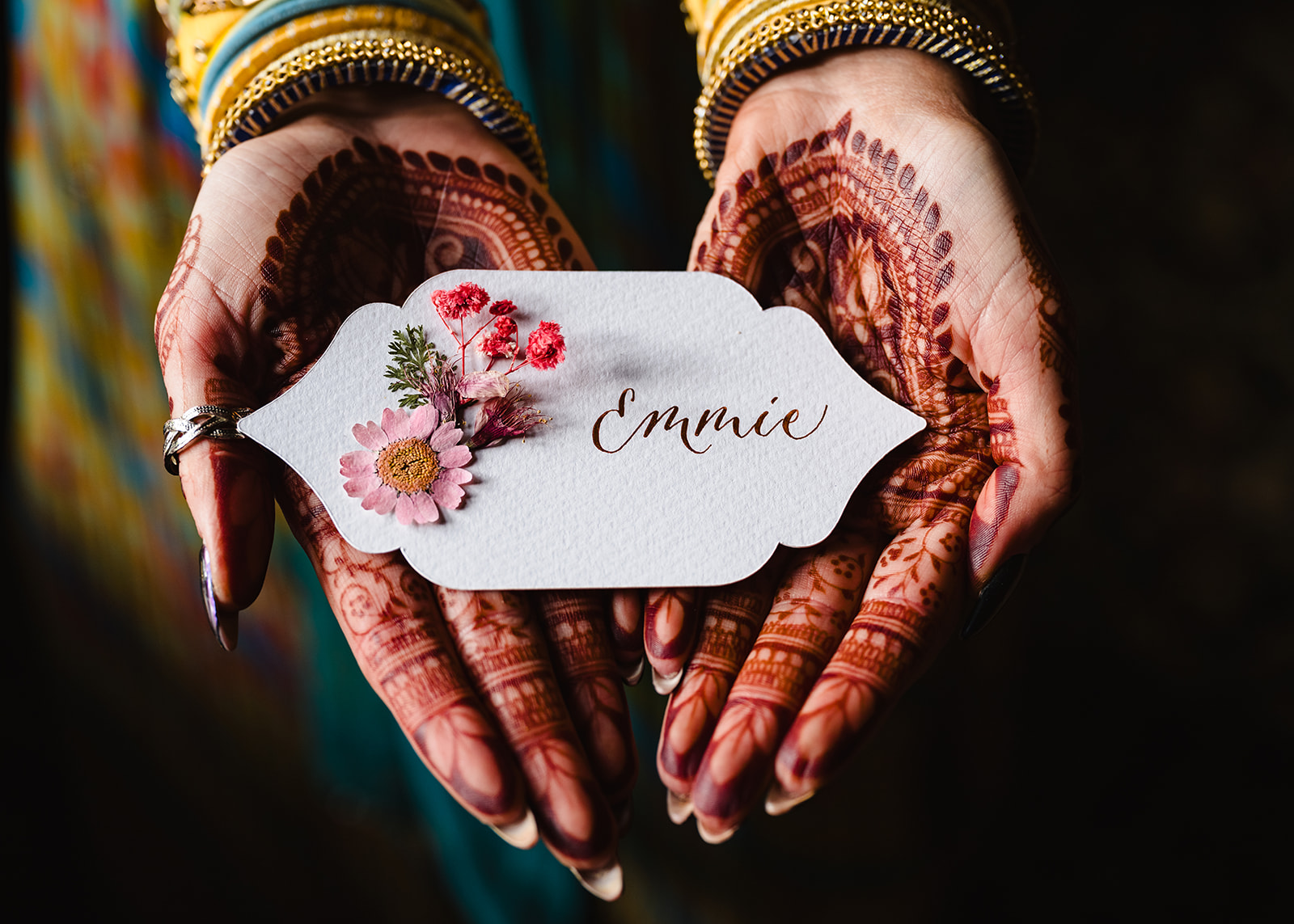 Close up of name card and brides hands with henna by Amanda Forman Photography
