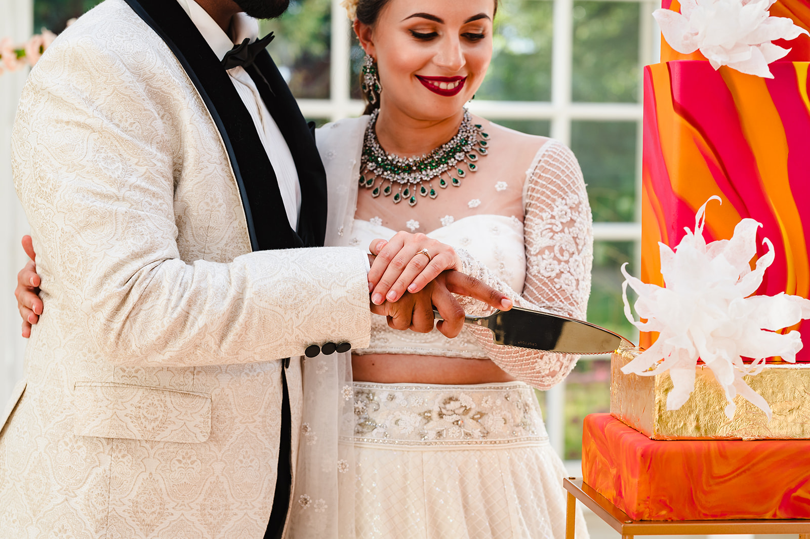 Bride and groom cutting their cake indian wedding photoshoot at stapleford park by Amanda Forman Photography