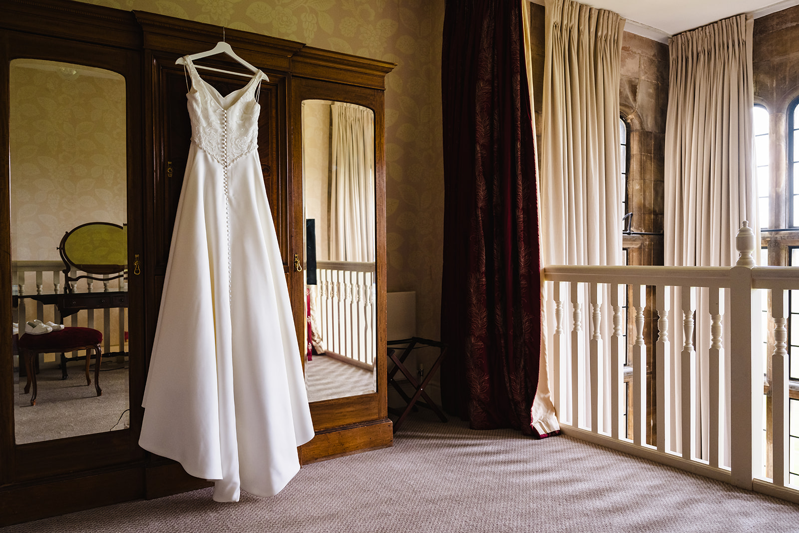 Stapleford park bridal prep room dress hanging on door by Amanda Forman Photography