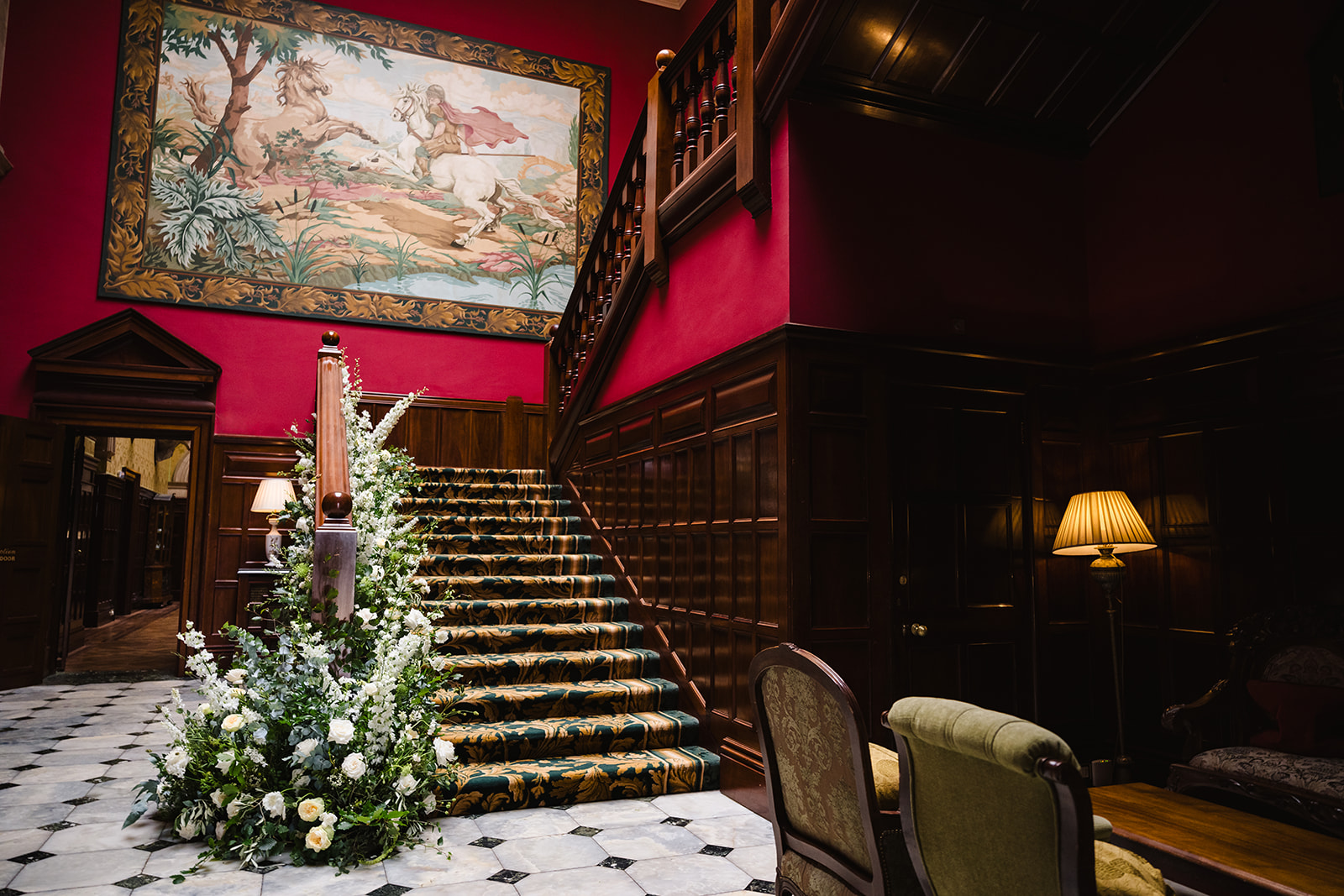 Staircase at stapleford park wedding addorned with flowers by Amanda Forman Photography
