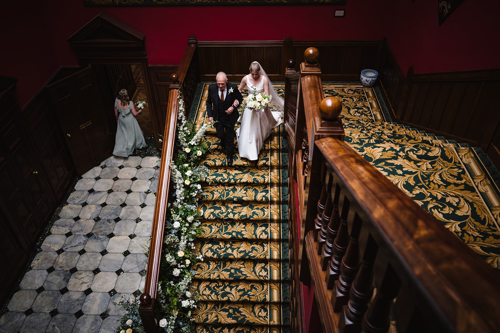 Bride and her father walking down the stairs at Stapleford park by Amanda Forman Photography